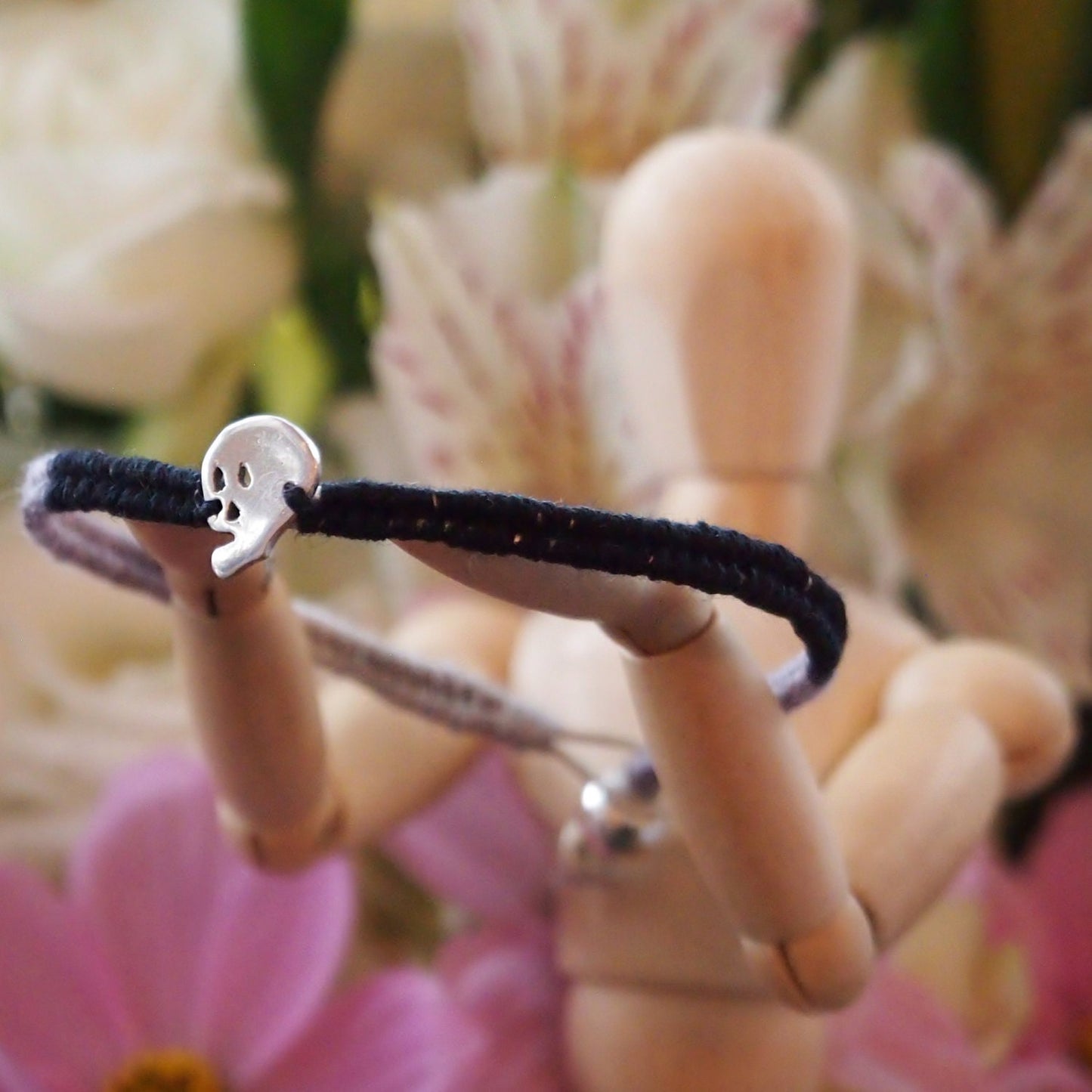 A lovely black and grey leather and cotton friendship bracelet with fine silver skull.