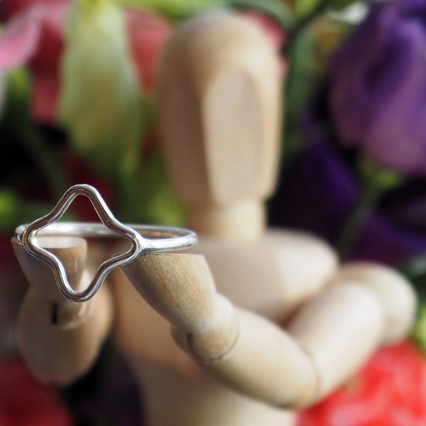An adorable perfectly simple sterling silver wire 4 point star ring.