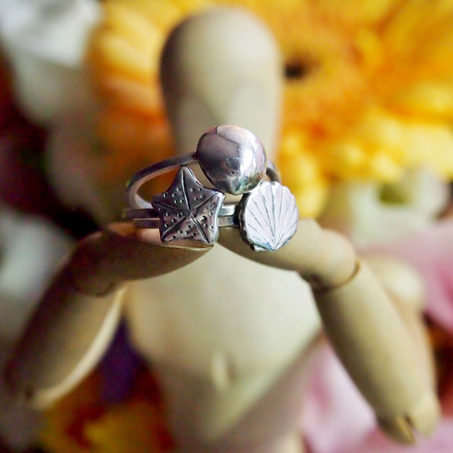 A super simple fine silver scallop shell on a square sterling silver ring.