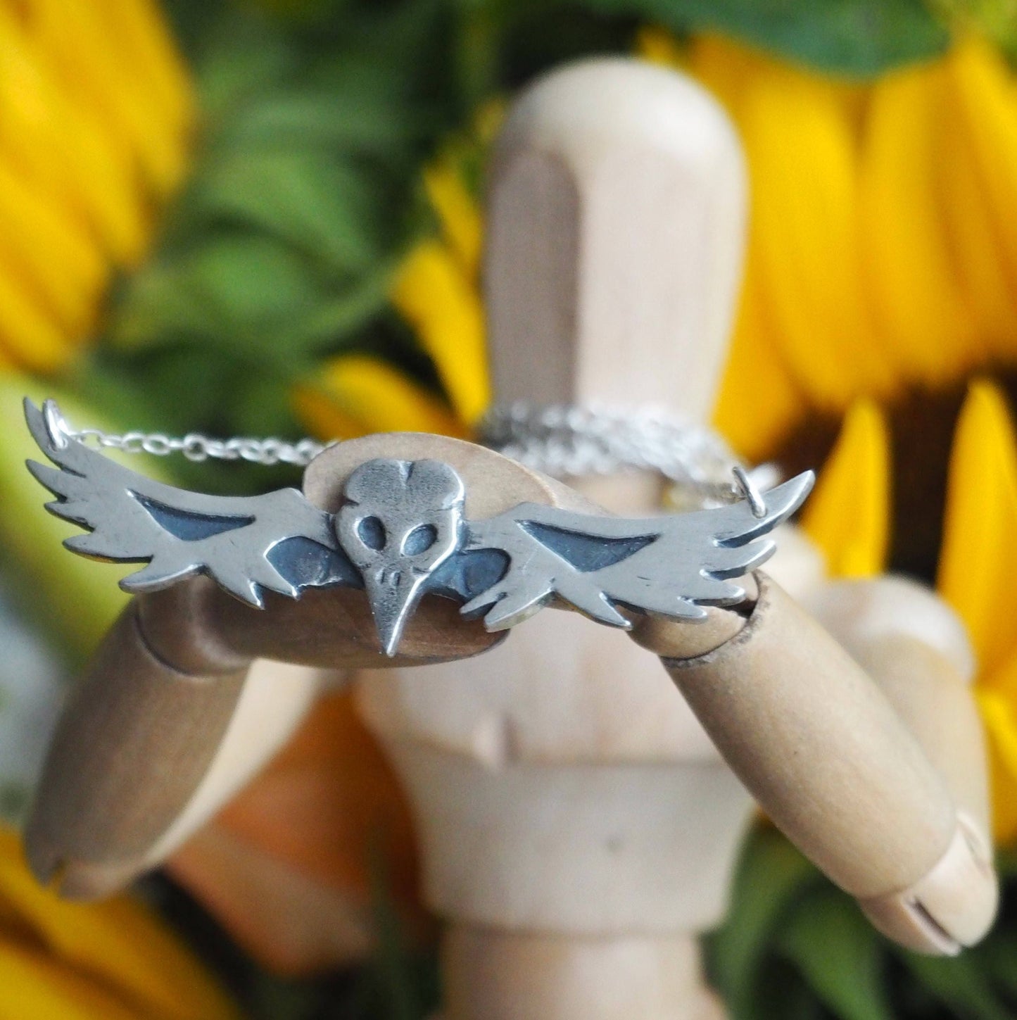 A beautiful gothic tattoo inspired fine silver flying bird skull necklace on a sterling silver chain.