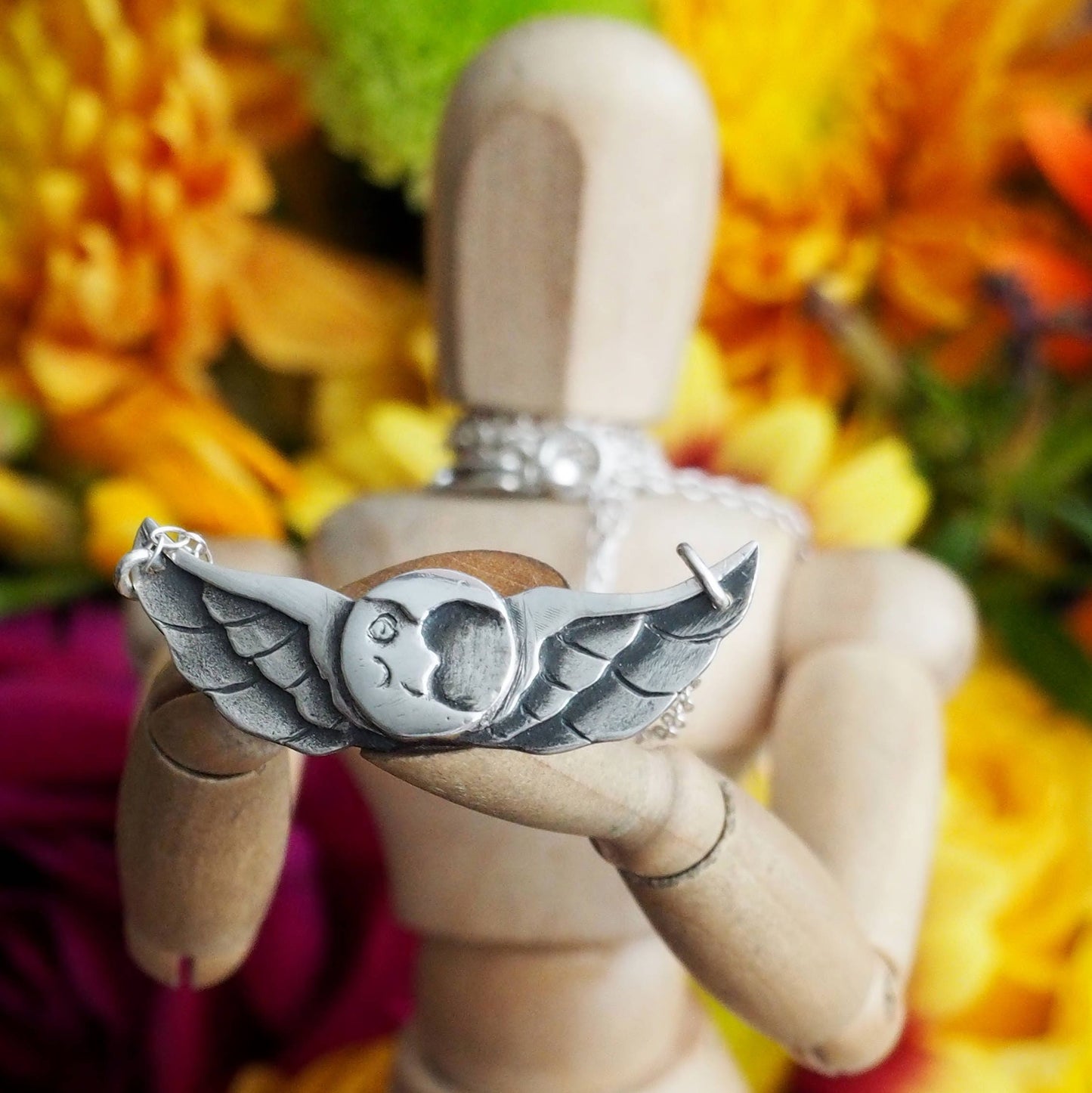 A beautiful tattoo inspired winged moon necklace hand made fine silver on a sterling silver chain.