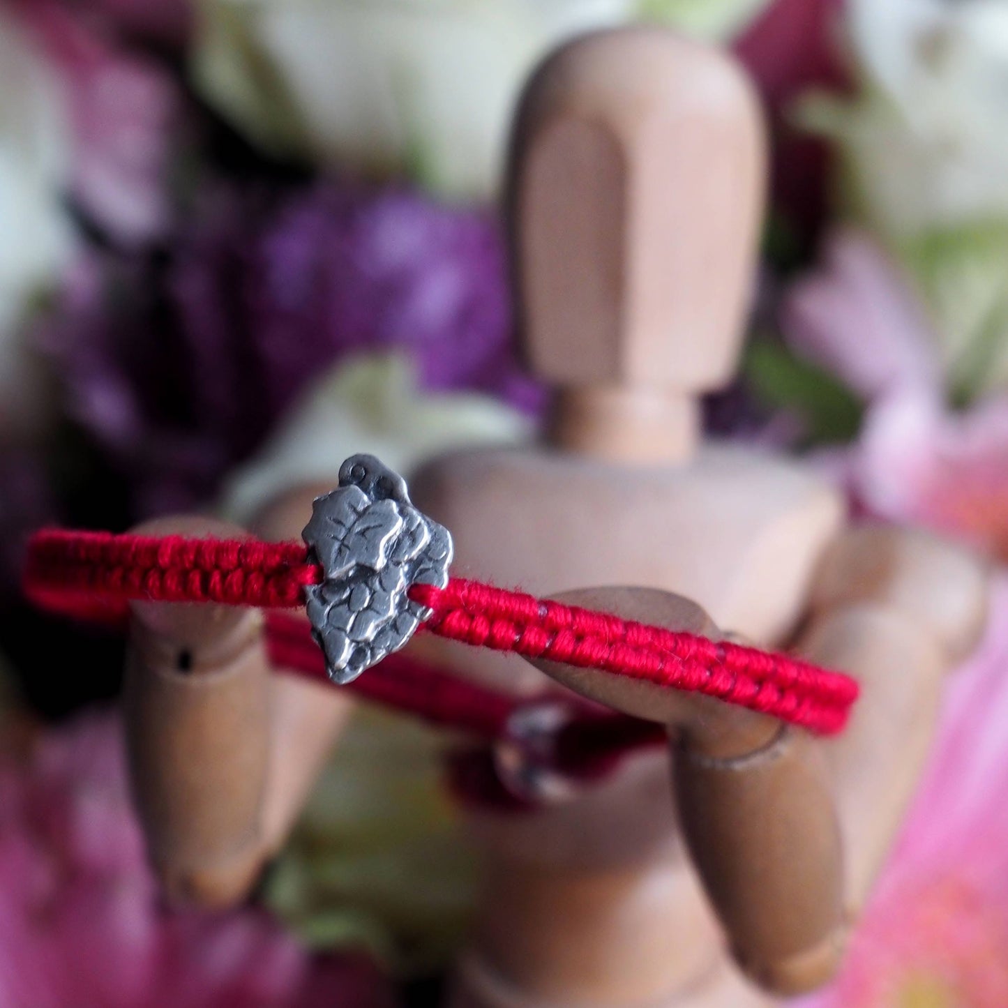 A gorgeous red leather and cotton friendship bracelet with a lovely tiny fine silver bunch of grapes.
