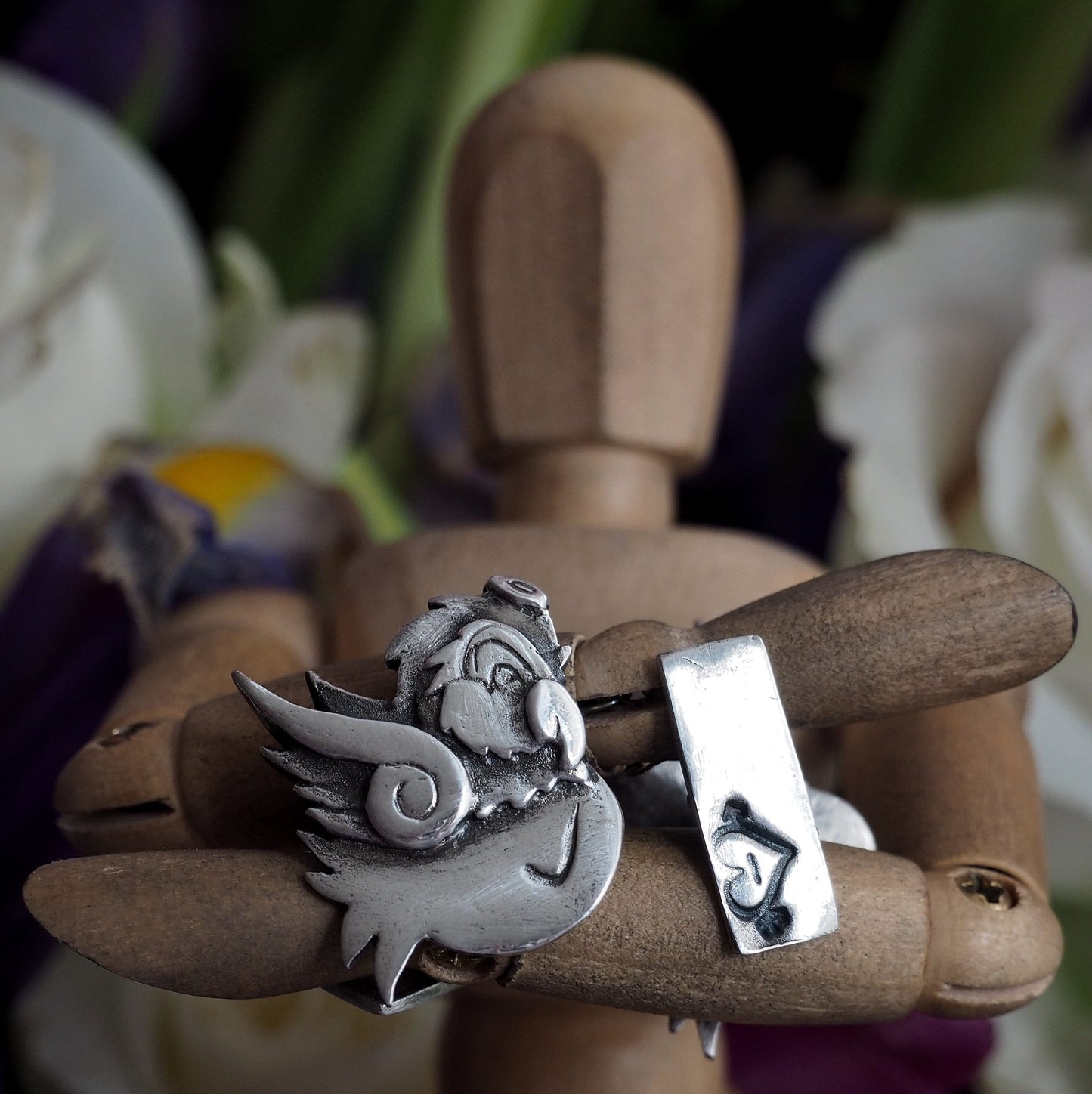 A beautiful tattoo style pair of 'angel' and 'devil' fine silver cufflinks, secured with sterling silver chain.