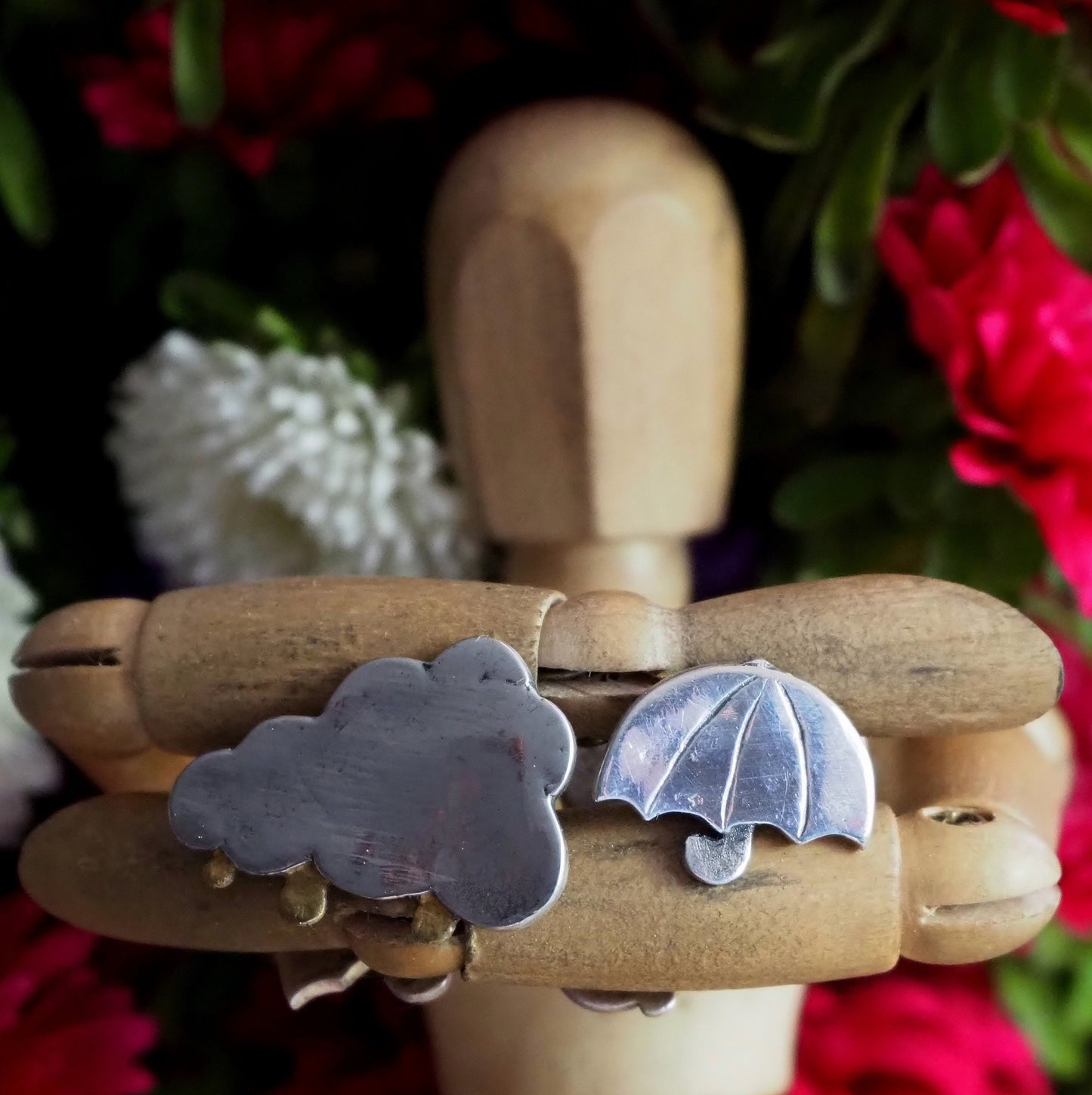 A gorgeous pair of cloud cufflinks with with golden raindrops and umbrella backs in fine silver. Secured with handmade sterling silver chain