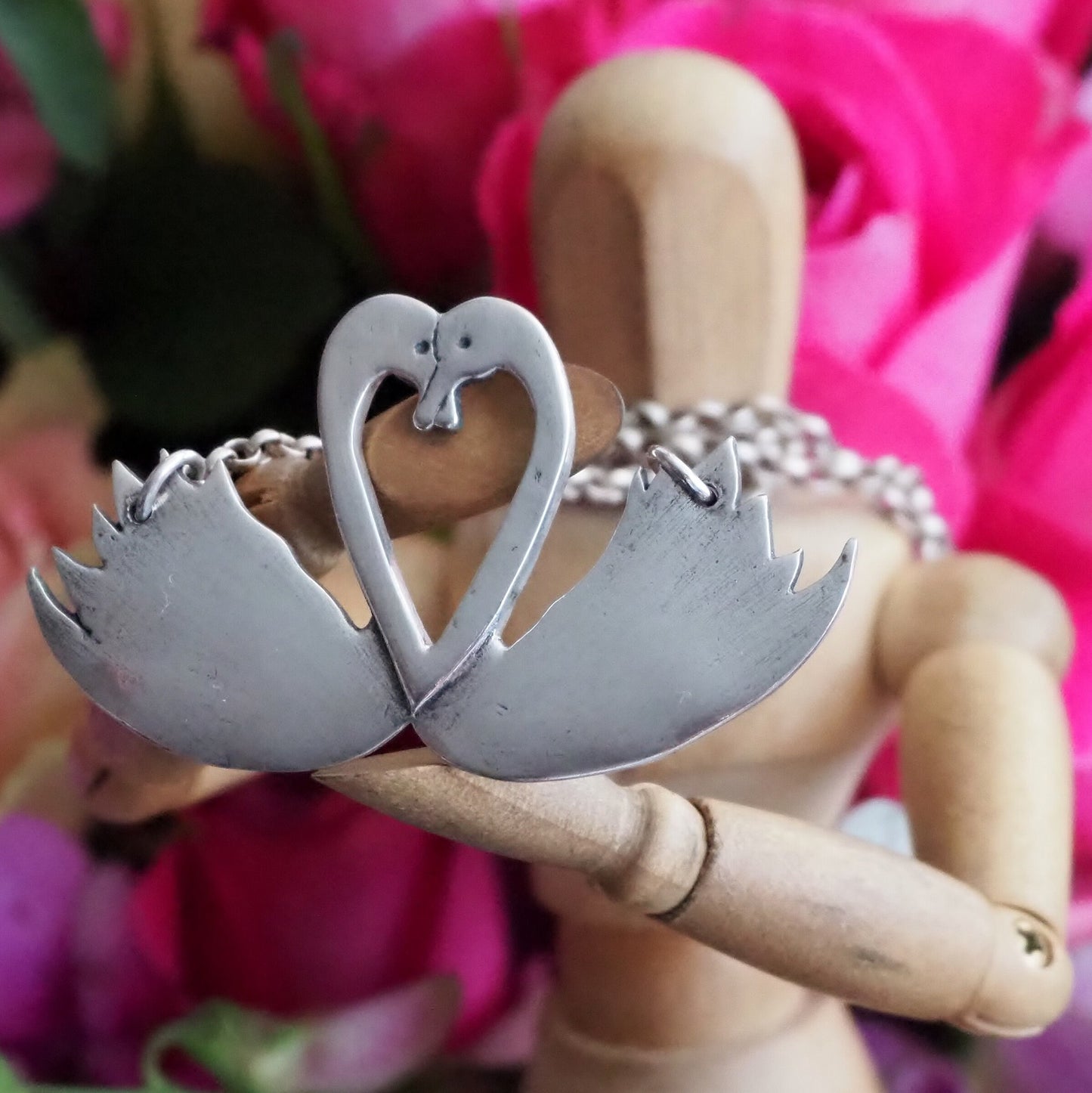 A beautiful pair of swans, handmade in fine silver on a sterling silver chain necklace.