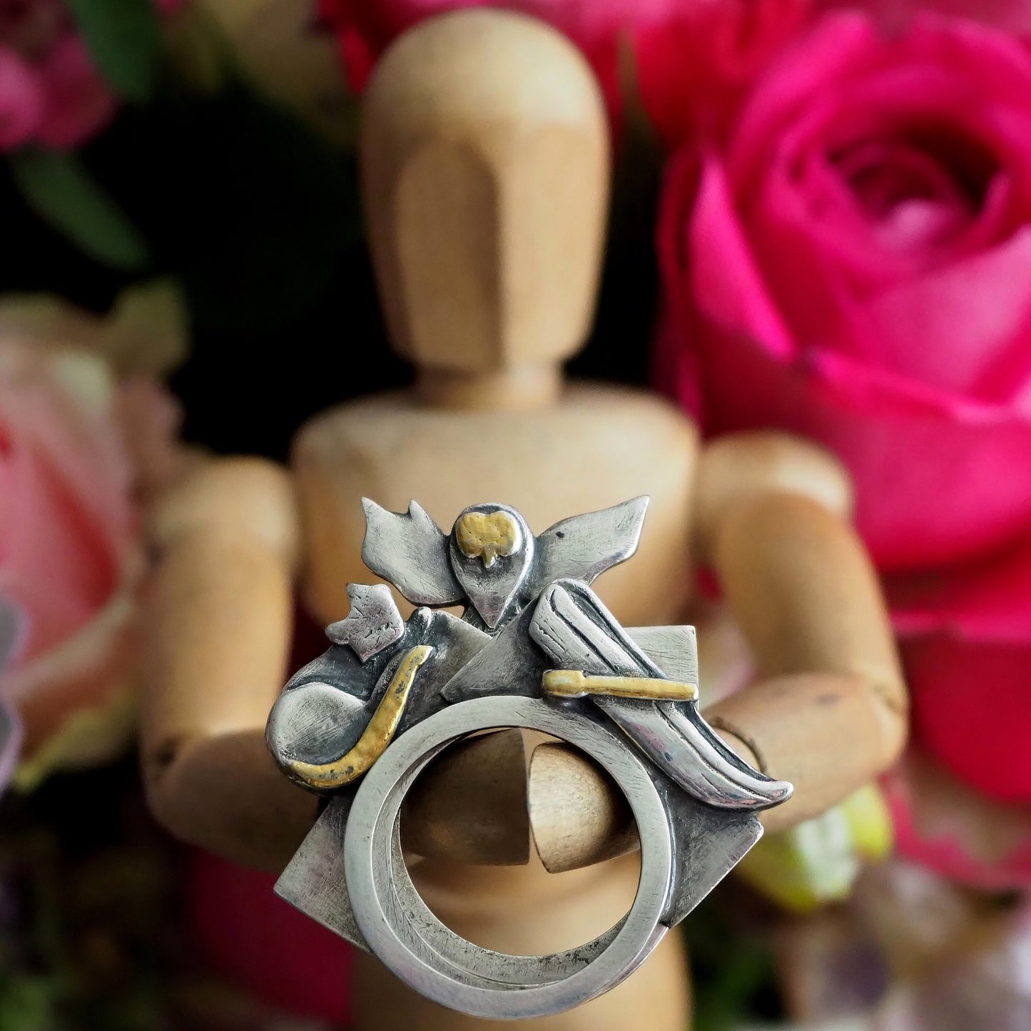 A stack of rings hand made in fine silver with touches of gold telling the classic tale of the owl and the pussy cat sailing in their boat