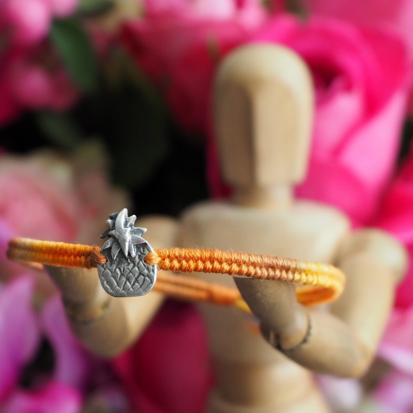 A simple summer yellow leather and cotton friendship bracelet with a tiny unique handmade fine silver pineapple