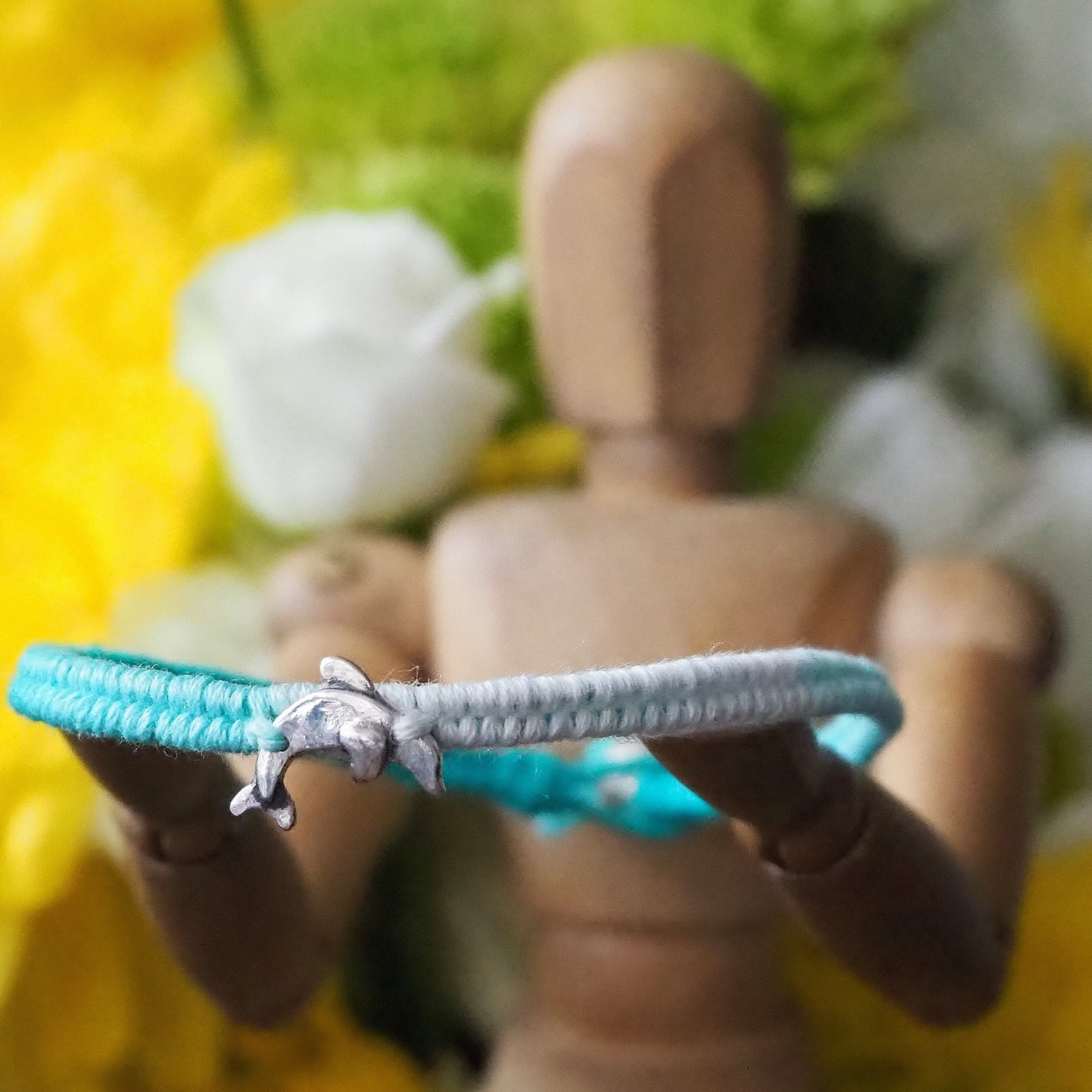 A gorgeous turquoise leather, cotton and sterling silver friendship bracelet with a lovely tiny unique handmade fine silver dolphin.
