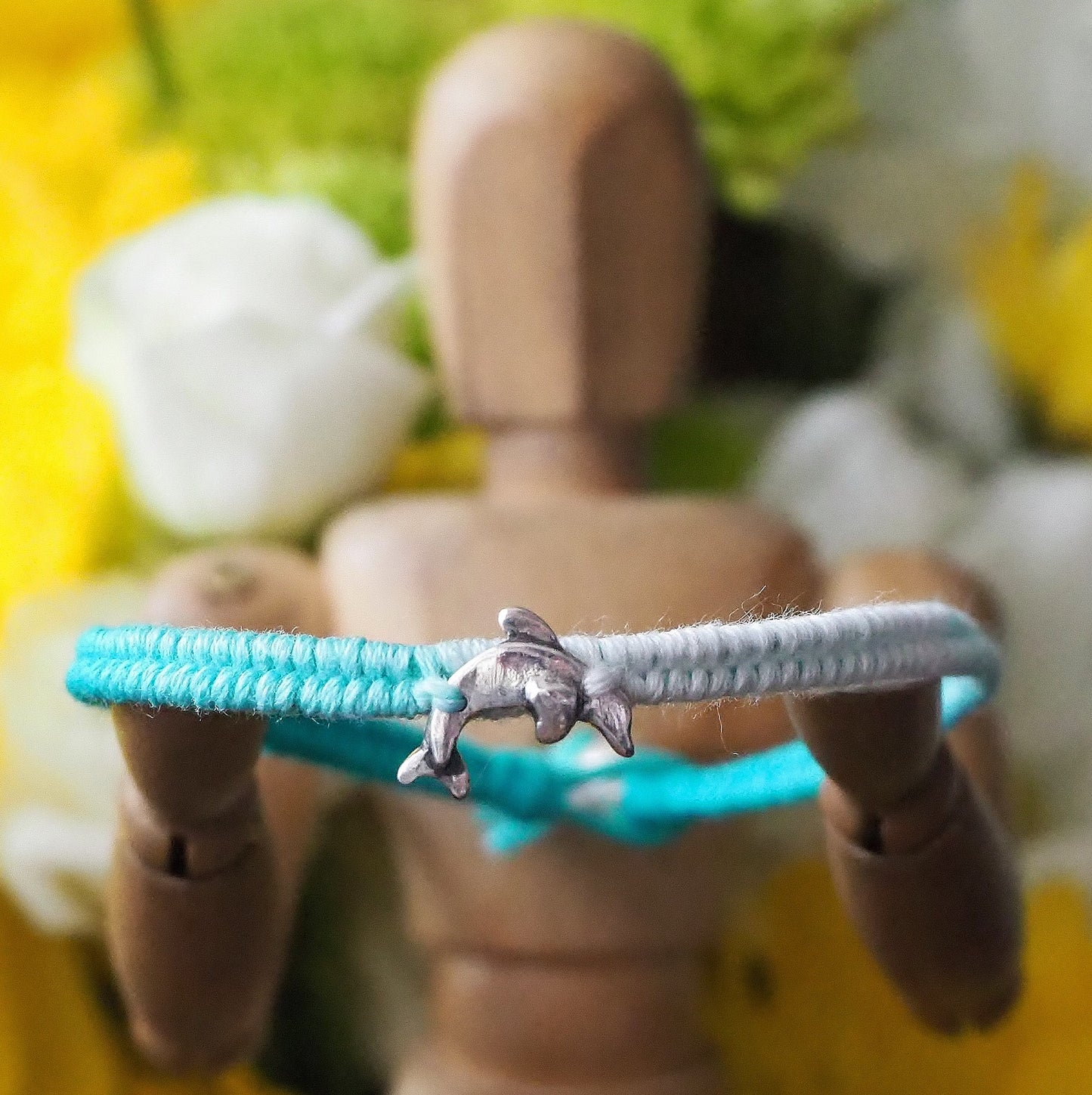 A gorgeous turquoise leather, cotton and sterling silver friendship bracelet with a lovely tiny unique handmade fine silver dolphin.