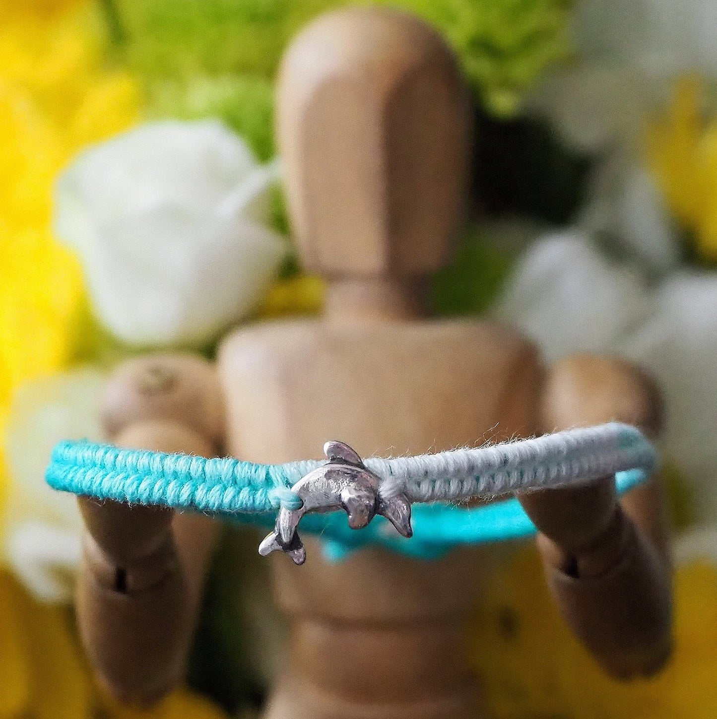 A gorgeous turquoise leather, cotton and sterling silver friendship bracelet with a lovely tiny unique handmade fine silver dolphin.