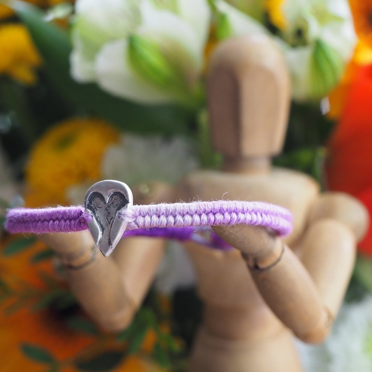 A lovely handmade fine silver owl on a purple leather, sterling silver and cotton friendship bracelet.