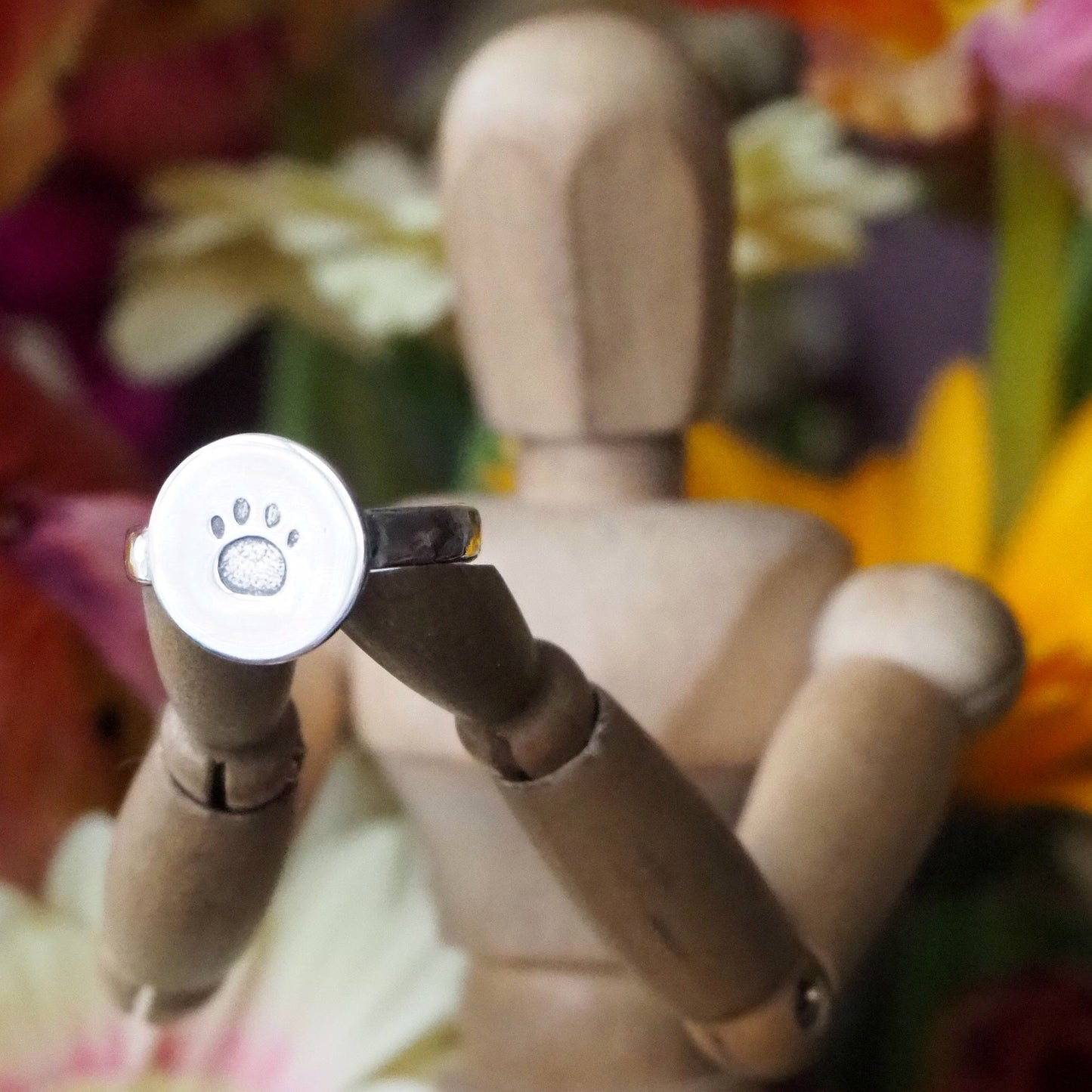 A perfectly simple handmade sterling silver disc ring with an adorable paw print.