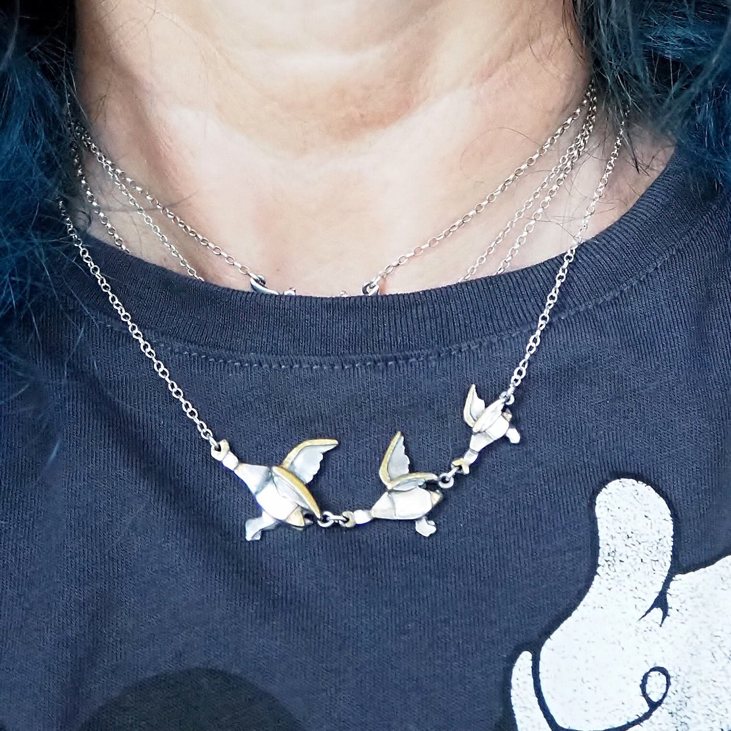 A gorgeous set of handmade unique fine silver flying ducks with gold highlights, hung on sterling silver necklace. Mrs Ogden would love them