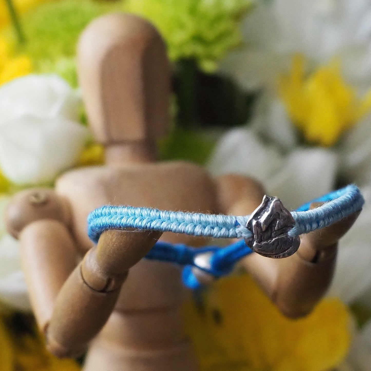 A beautiful blues friendship leather and cotton bracelet with a stunning fine silver mermaid finished with a sterling silver bead.