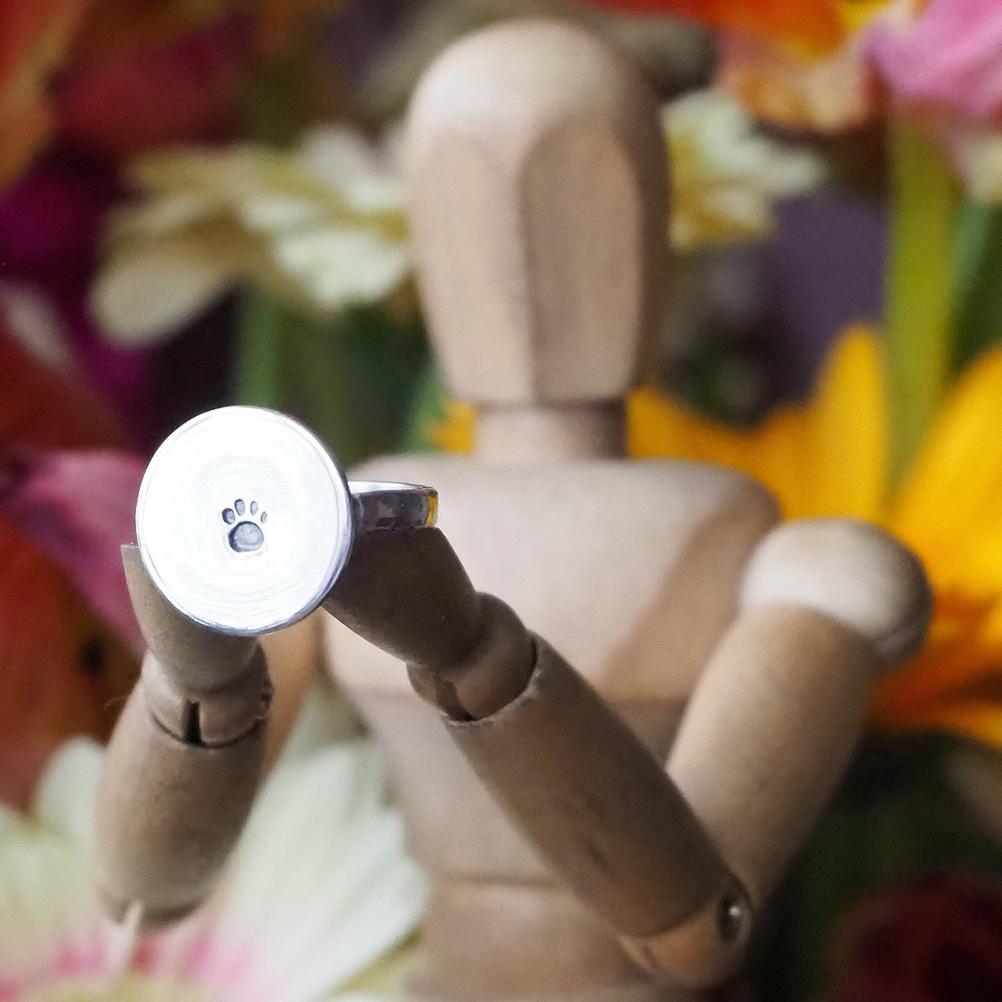 A perfectly simple handmade sterling silver ring with an adorable paw print disc.