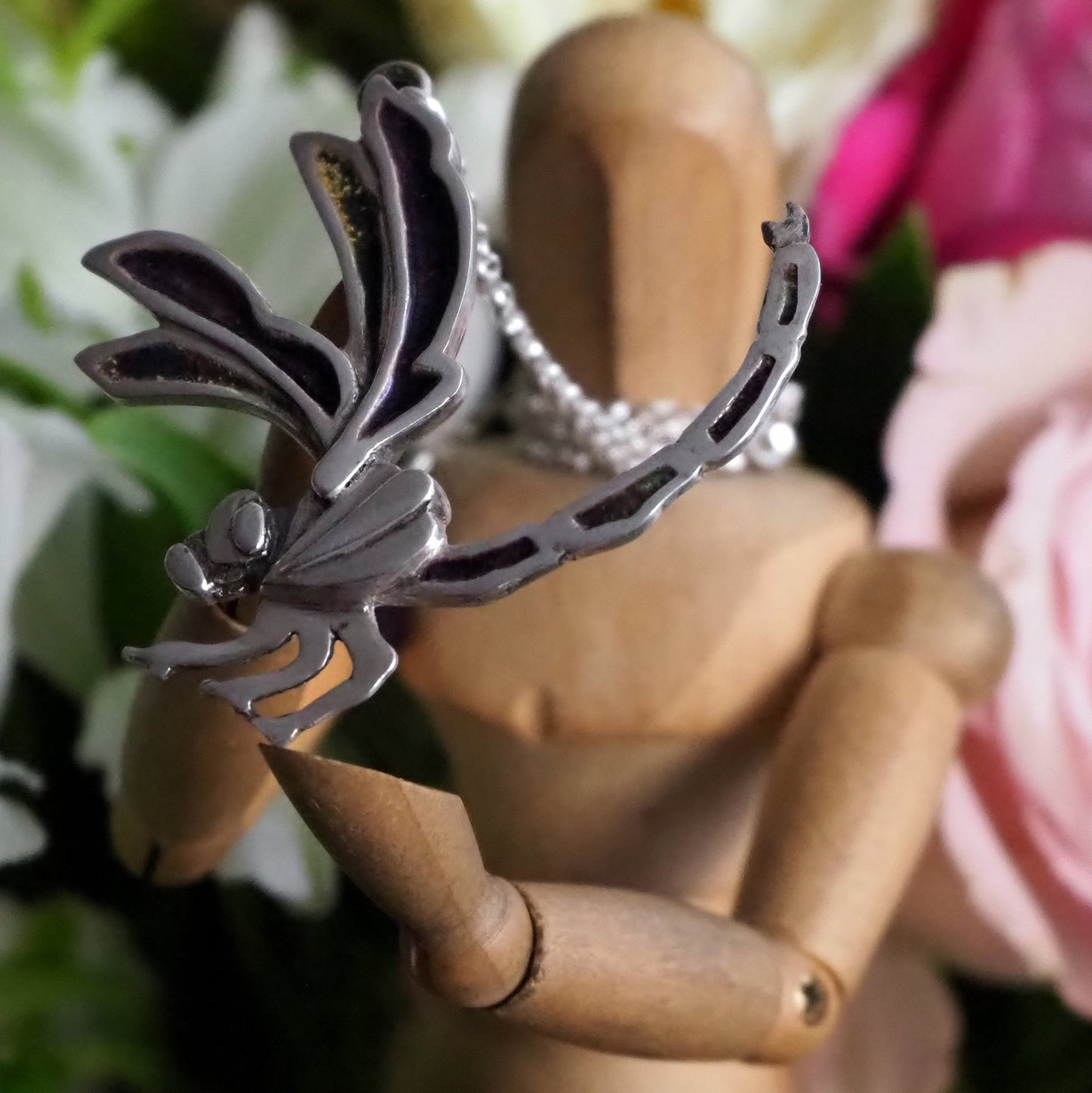 A beautiful dragonfly pendant, handmade in enamelled fine silver, hung on a sterling silver chain.