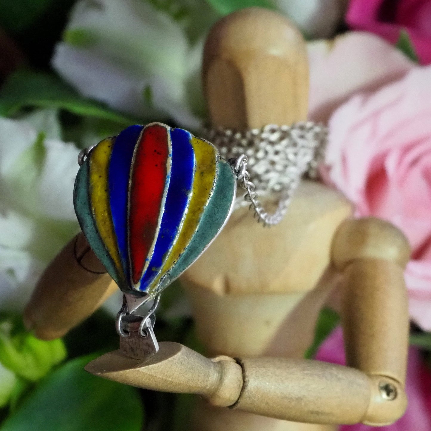 A beautiful hot air balloon pendant, handmade in fine silver and hand enamelled, hung on a sterling silver chain.