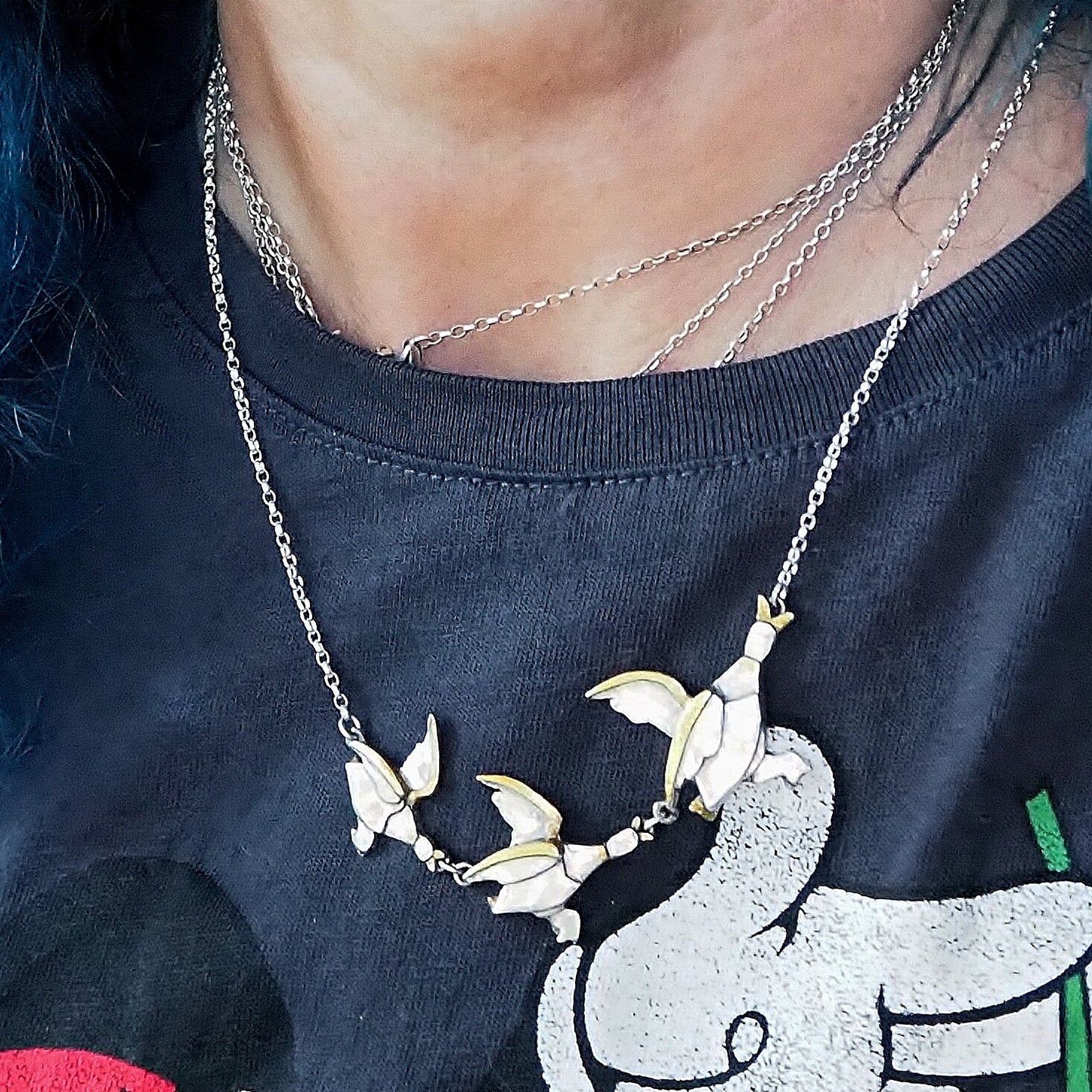A beautiful set of handmade unique fine silver flying ducks with gold highlights, hung on sterling silver necklace. Hilda would love them
