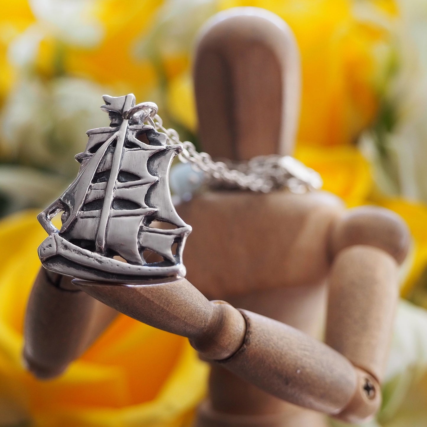 A gorgeous handmade fine silver two masted ship with beautifully detailed sails, a pendant on a long sterling silver chain.