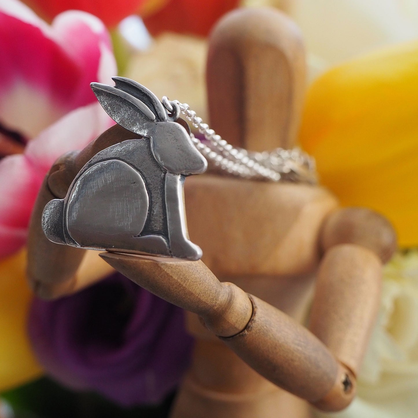 A beautiful fine silver bunny rabbit pendant on a sterling silver chain.