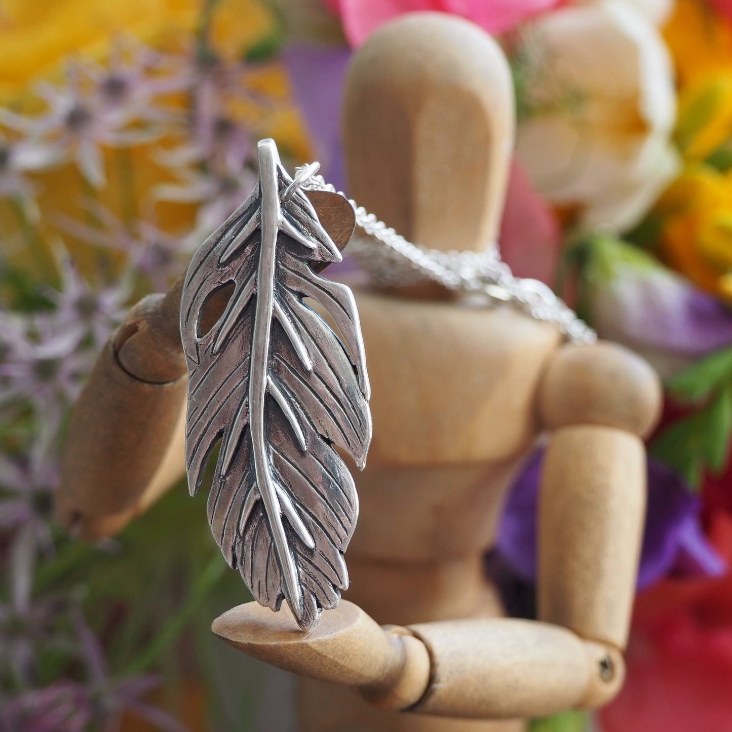 A gorgeous unique tropical banana leaf handmade in fine silver on a sterling silver necklace.