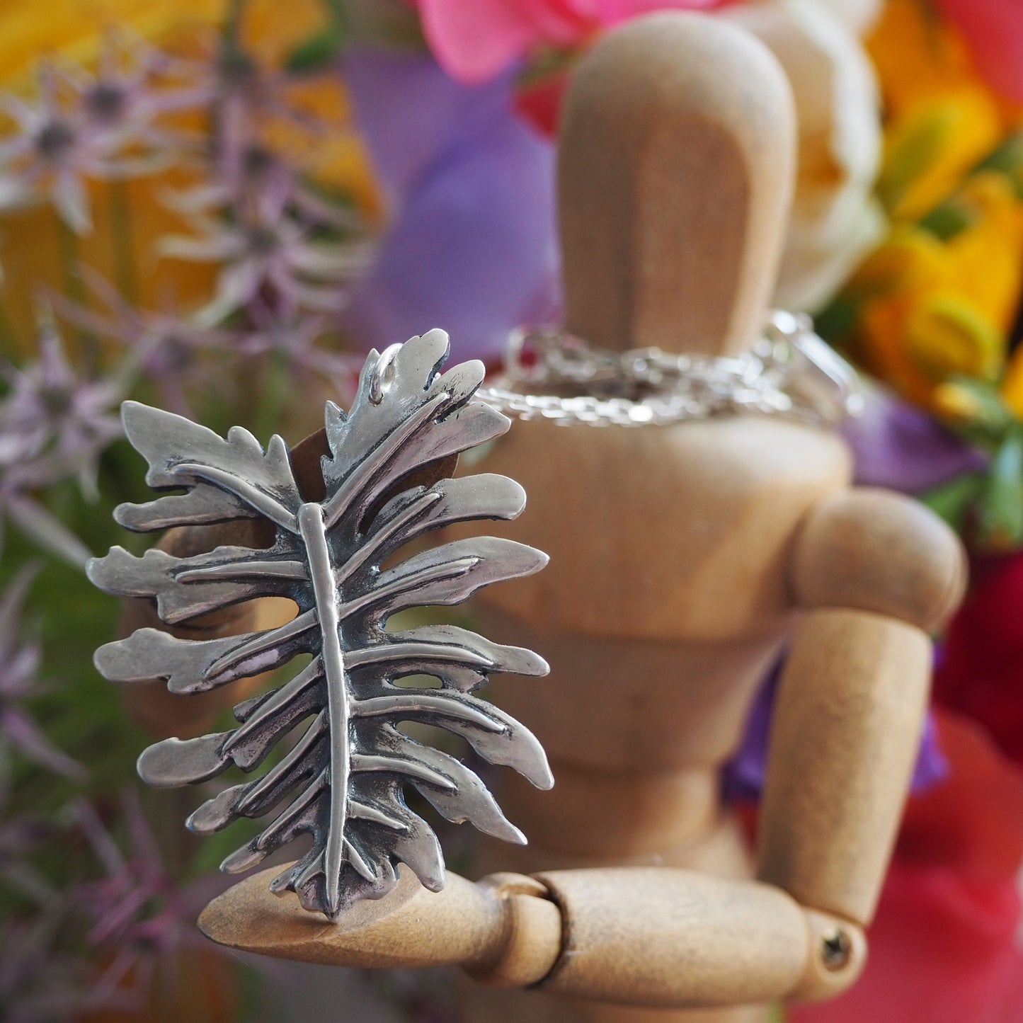 A gorgeous large tropical philodendron leaf handmade in eco friendly fine silver on a sterling silver necklace.