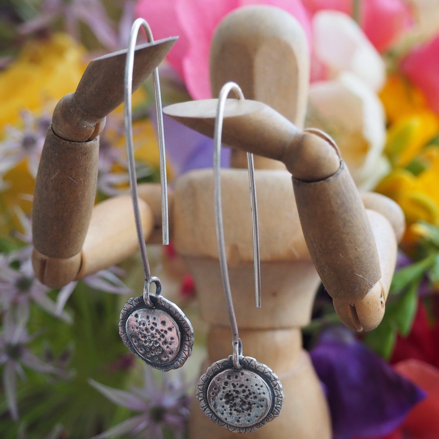 A gorgeously simple sunflower earrings handmade in fine silver and hung on long sterling silver wires.