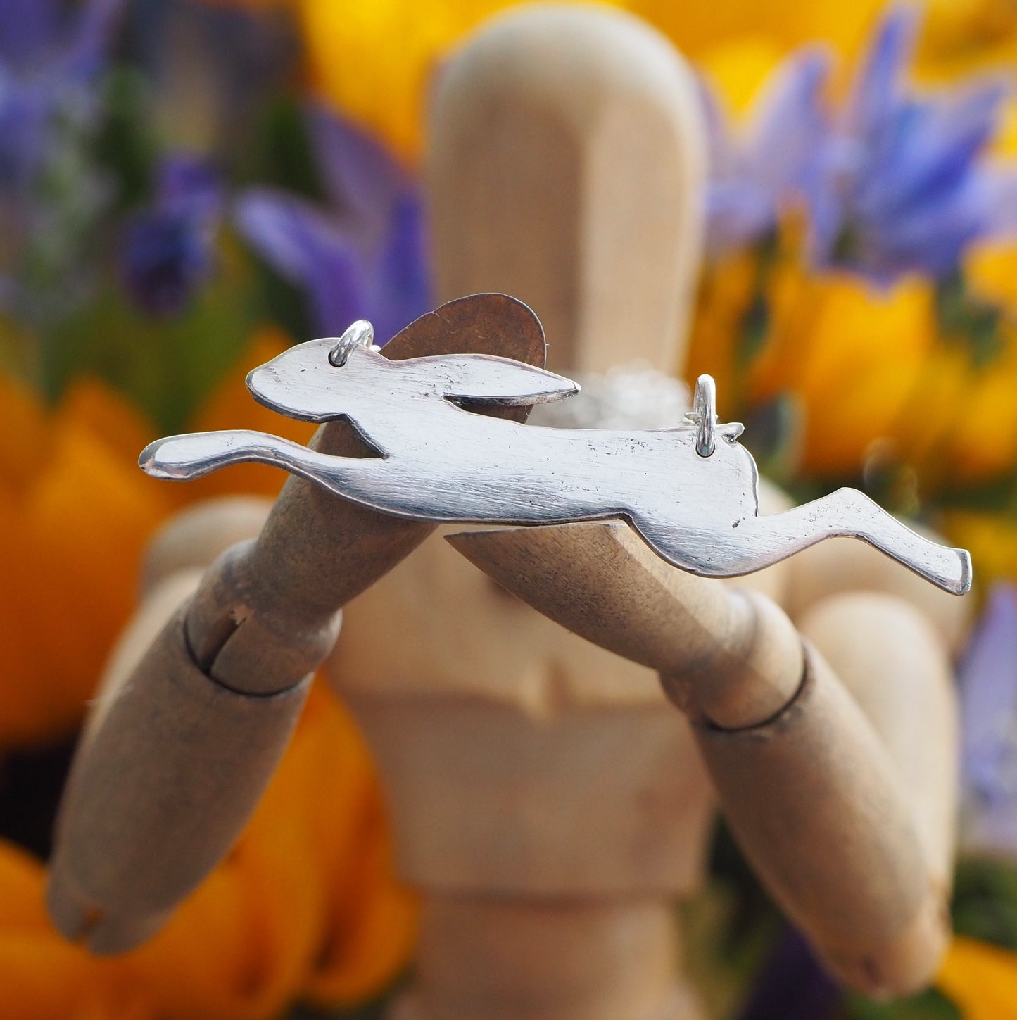 A wonderfully simple leaping hare necklace hand made in fine silver on a sterling silver chain.