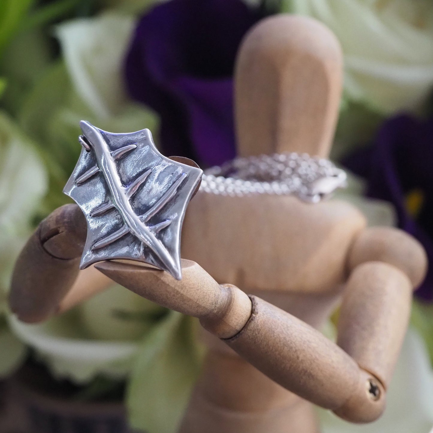 A gorgeous unique holly leaf handmade in eco friendly fine silver on a sterling silver necklace.