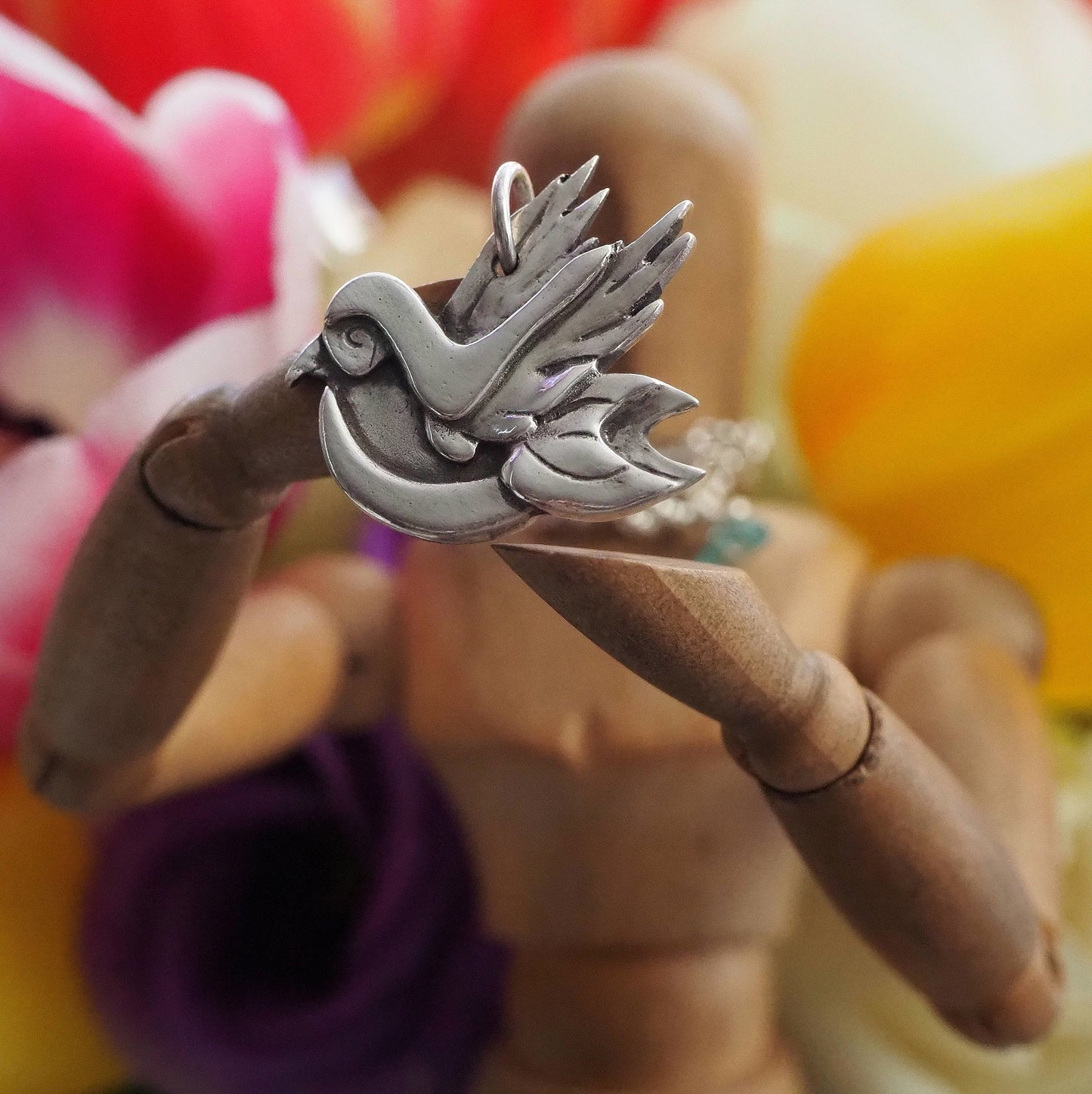 A wonderful little eco friendly fine silver tattoo inspired bird, a pendant on a sterling silver chain.