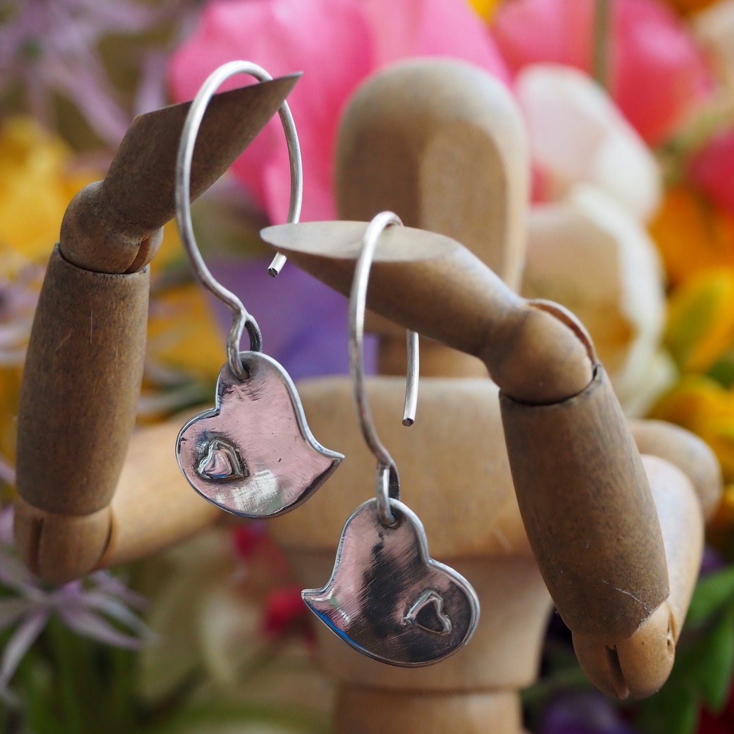 A pair of lovely simple little heart earrings handmade in fine silver on handmade sterling silver wires.