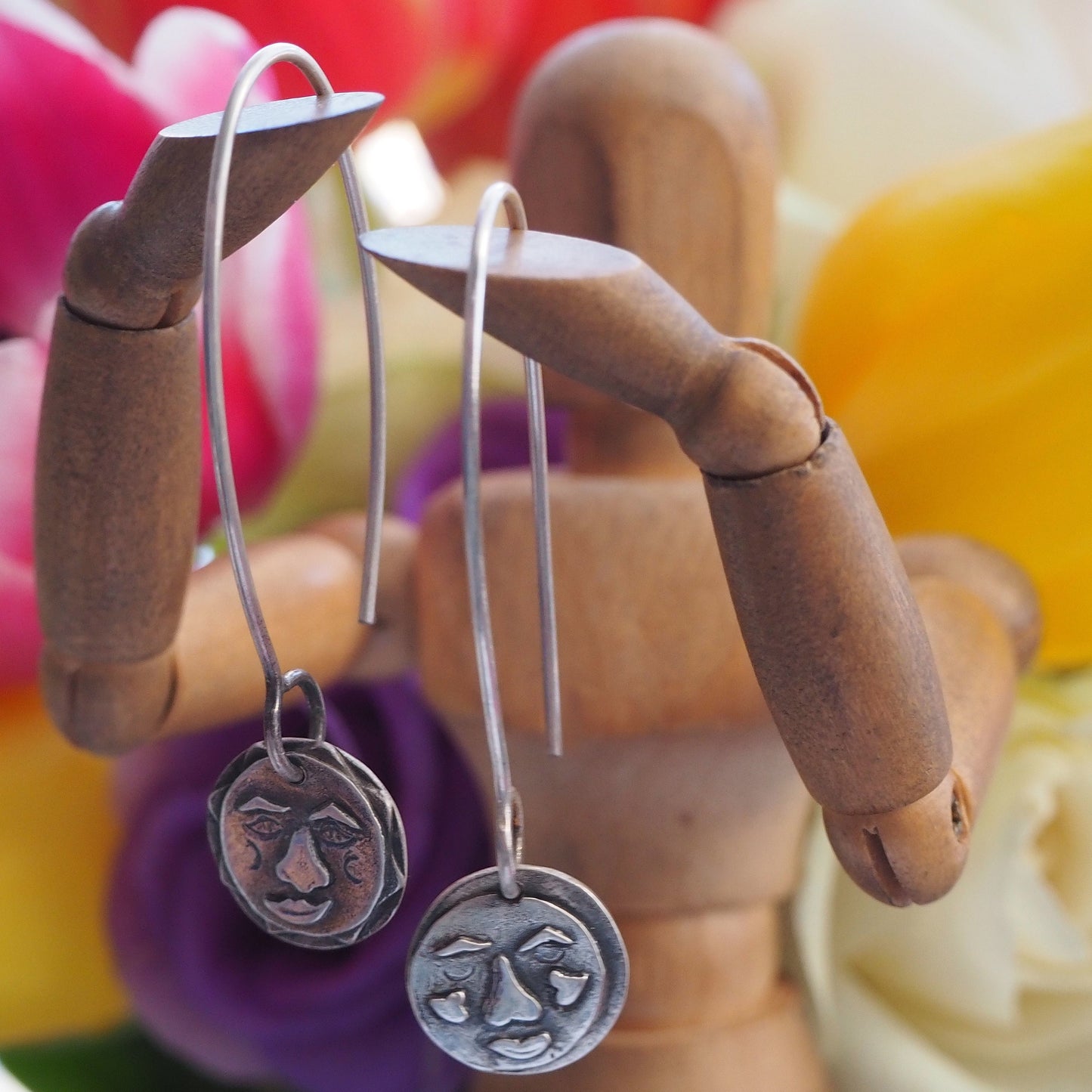 A gorgeous handmade pair of eco friendly fine silver moon and sun earrings on long 925 sterling silver wires