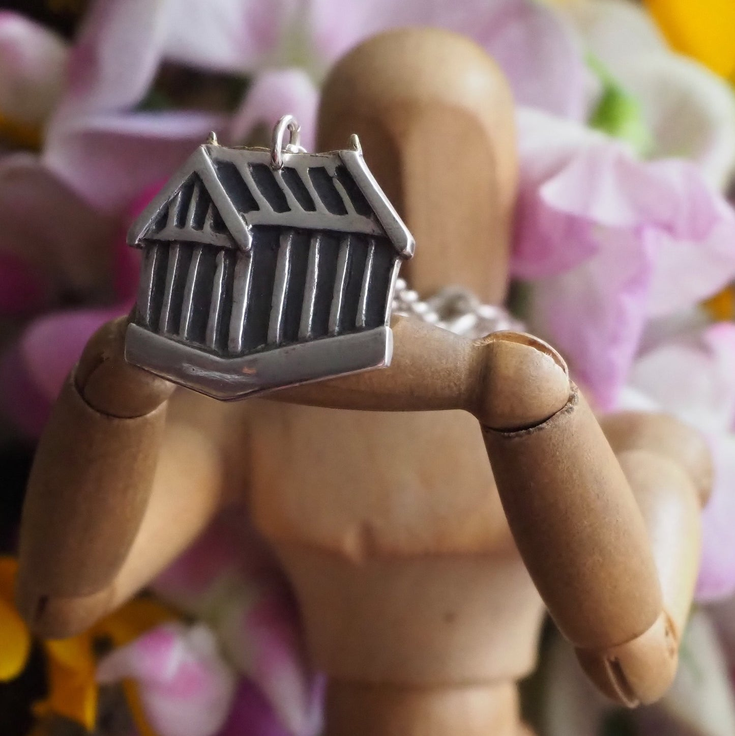A beautiful classic eco friendly fine silver greenhouse pendant hung on a sterling silver chain.