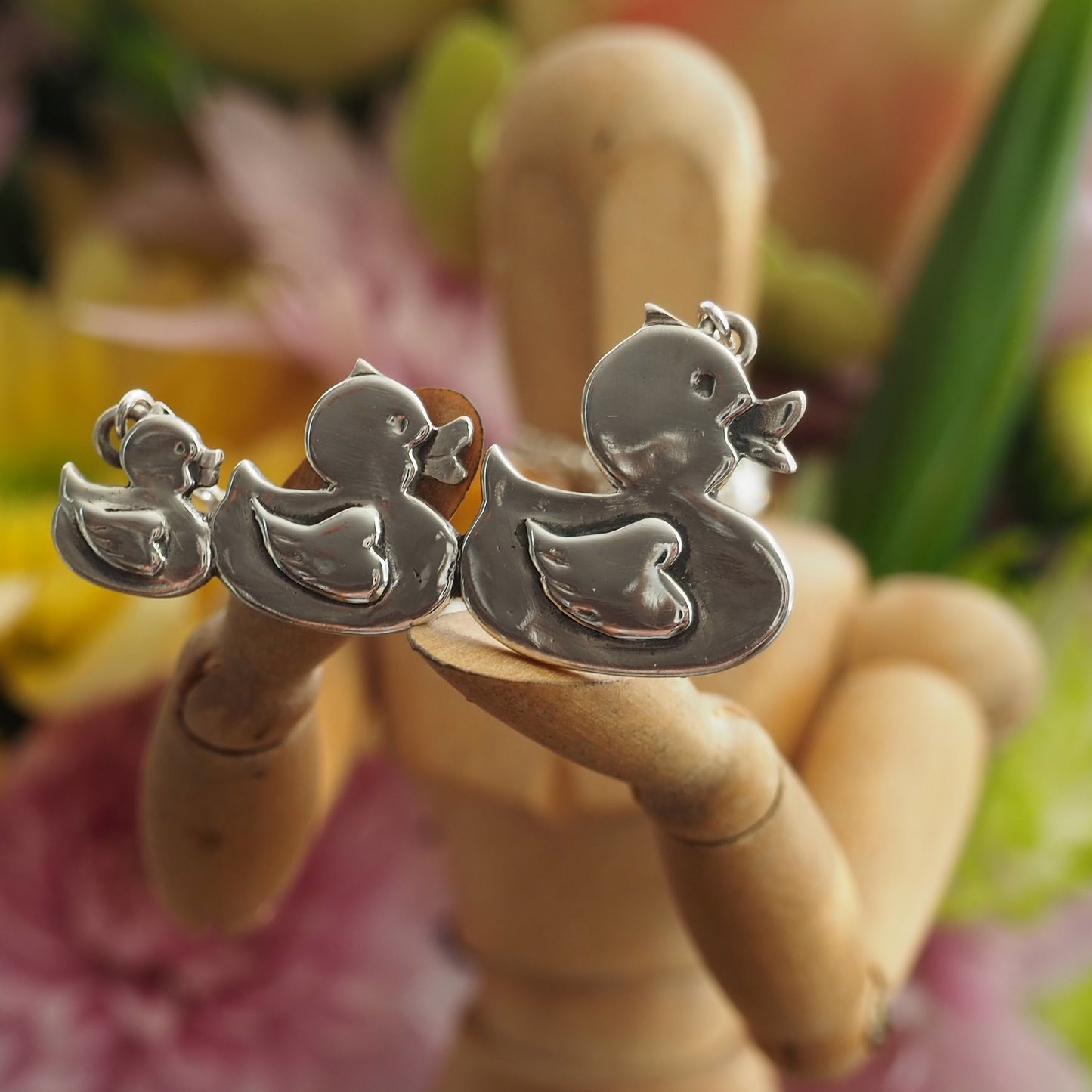 A gorgeous set of swimming rubber ducks, hand made in fine silver and hung on sterling silver chain