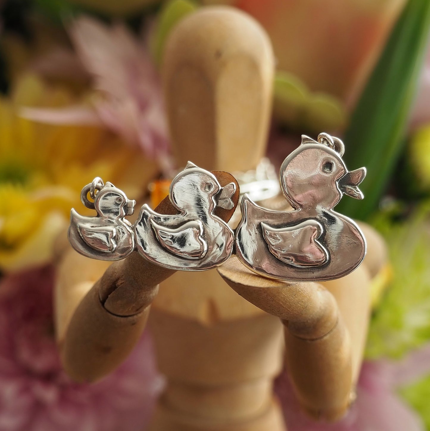A gorgeous set of swimming rubber ducks, hand made in fine silver and hung on sterling silver chain