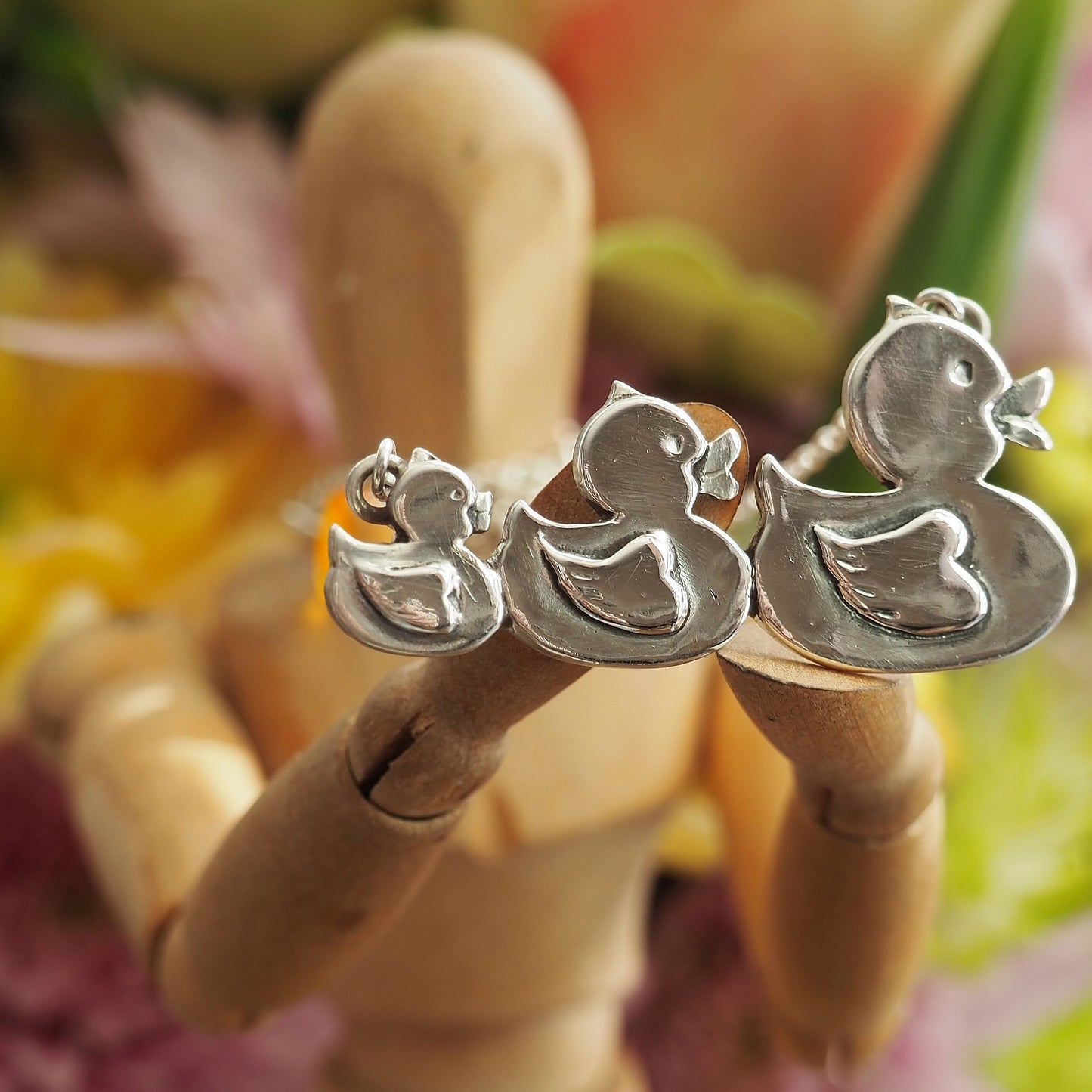 A gorgeous set of swimming rubber ducks, hand made in fine silver and hung on sterling silver chain
