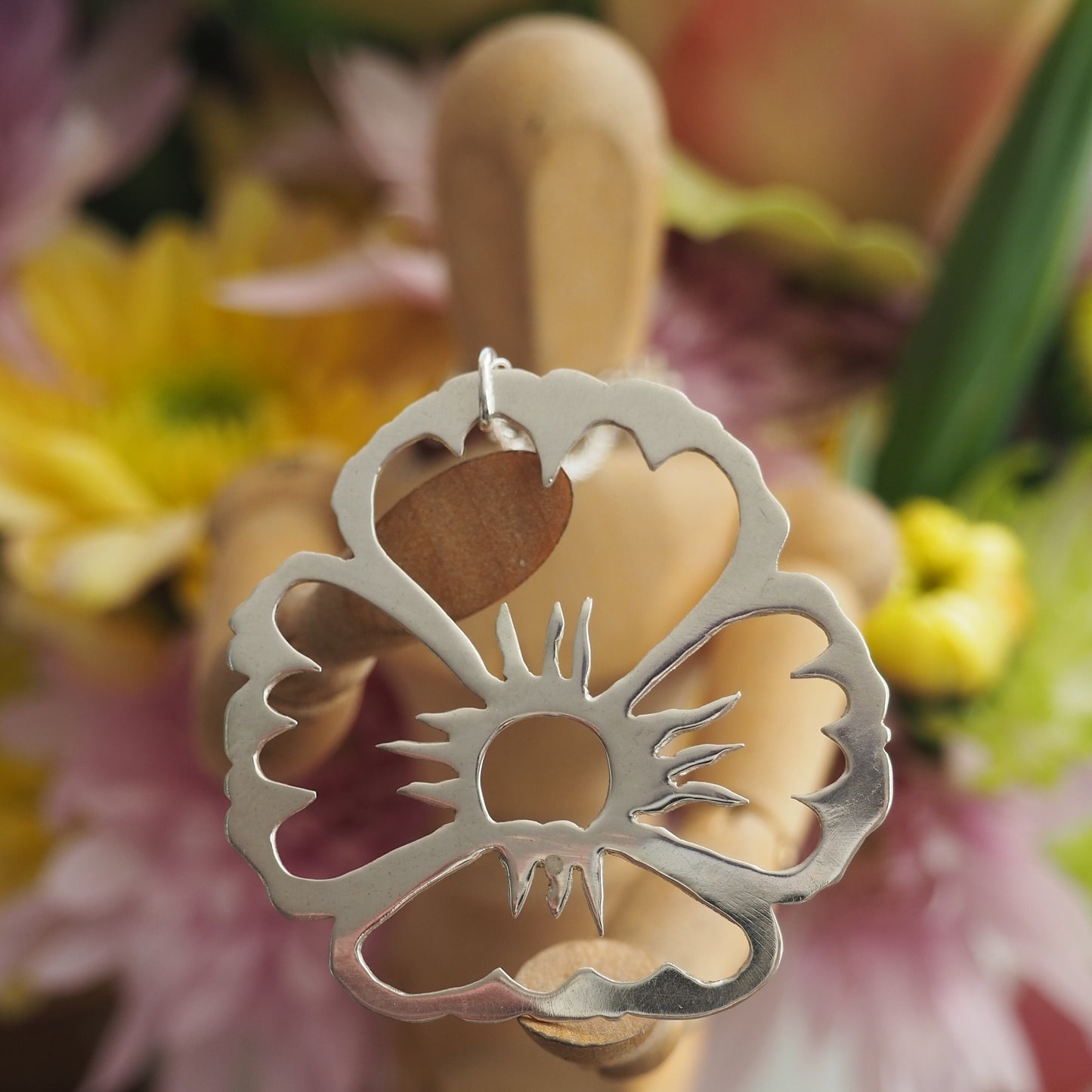 A gorgeously unique flower pendant hand cut in eco sterling silver on a sterling silver chain.