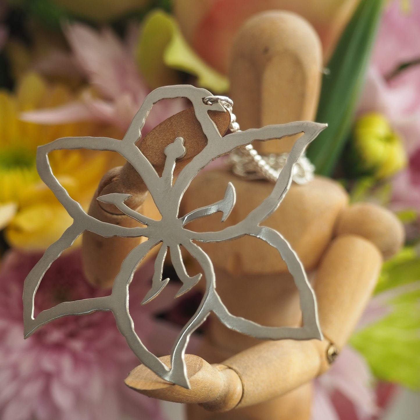 A stunning  unique lily flower pendant hand cut in recycled sterling silver on a sterling silver chain.