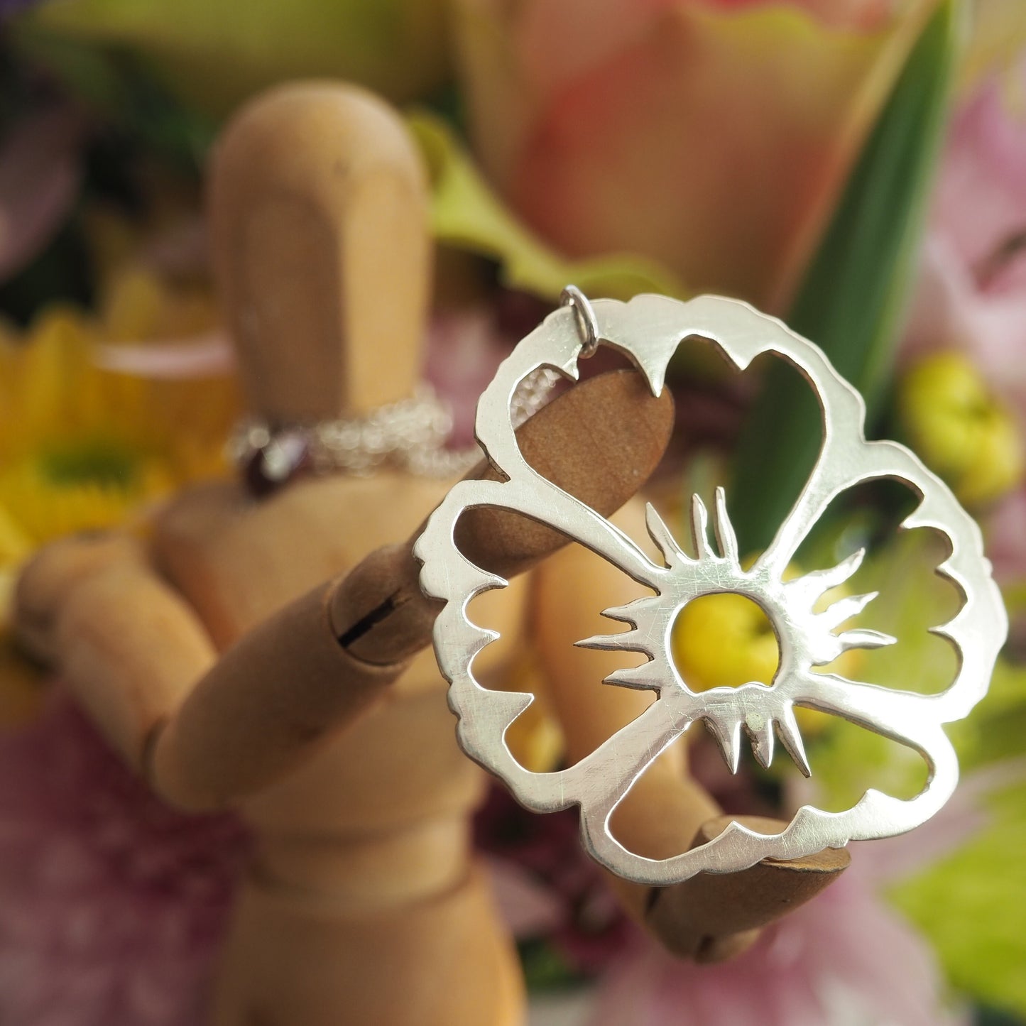 A gorgeously unique flower pendant hand cut in eco sterling silver on a sterling silver chain.