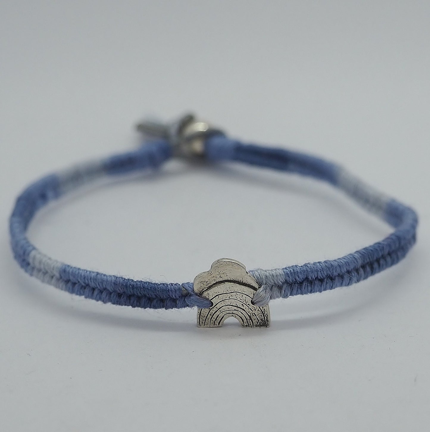 A beautiful small sized grey blues fade leather, sterling silver and cotton friendship bracelet with a tiny fine silver cloud and rainbow