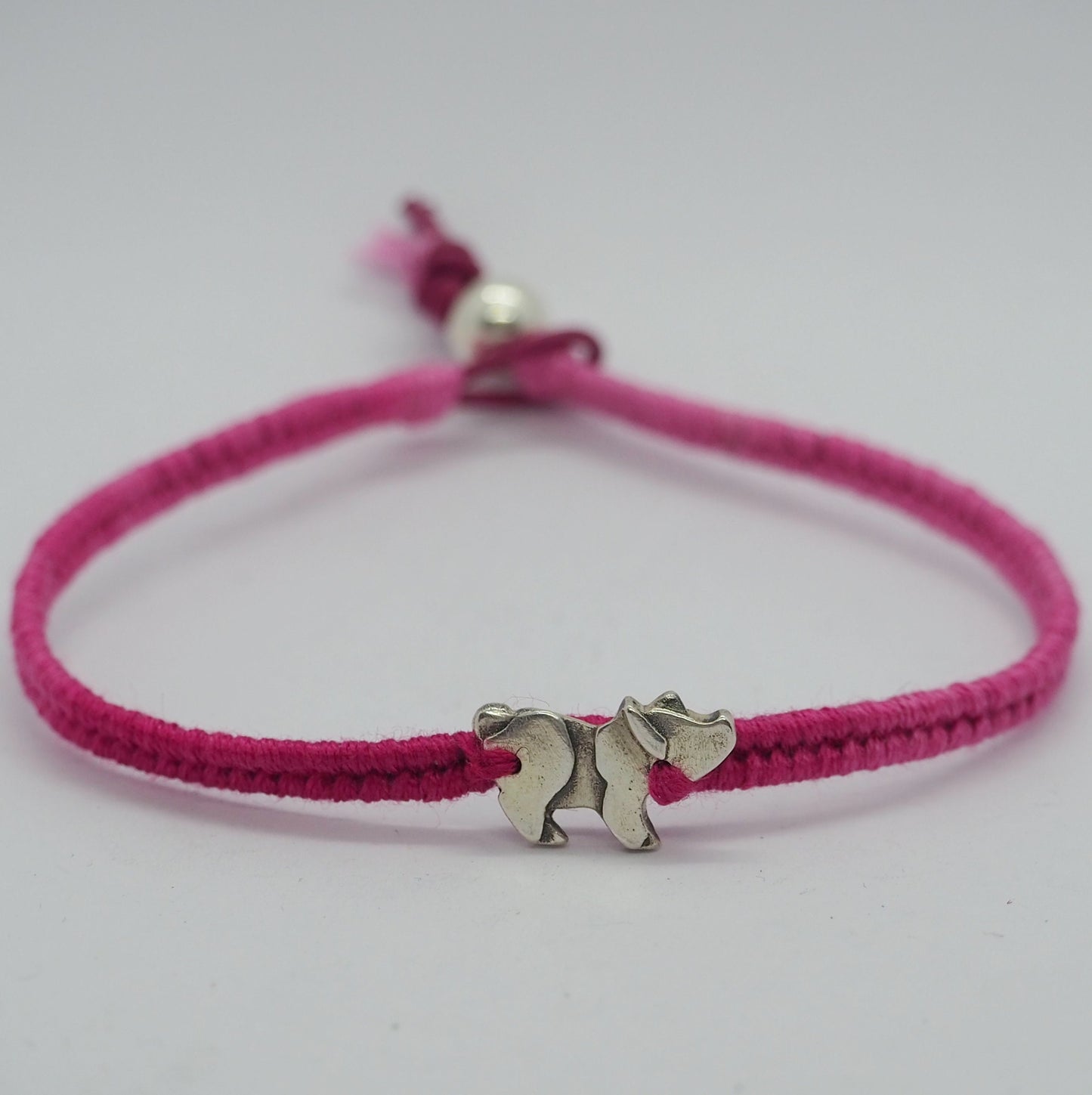 A unique adorable handmade fine silver pig charm on a beautiful deep pink leather, cotton and sterling silver friendship bracelet.