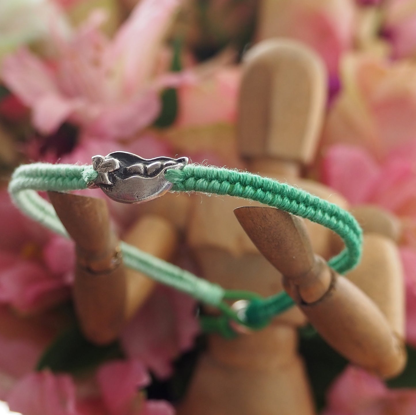 A gorgeous tropical palm tree hand made in fine silver on a fading green leather, cotton and sterling silver friendship bracelet.