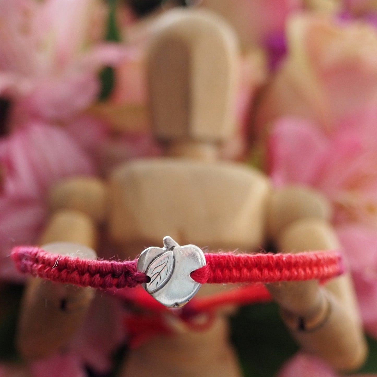 A gorgeous deep red leather and cotton friendship bracelet with a lovely tiny handmade fine silver apple.