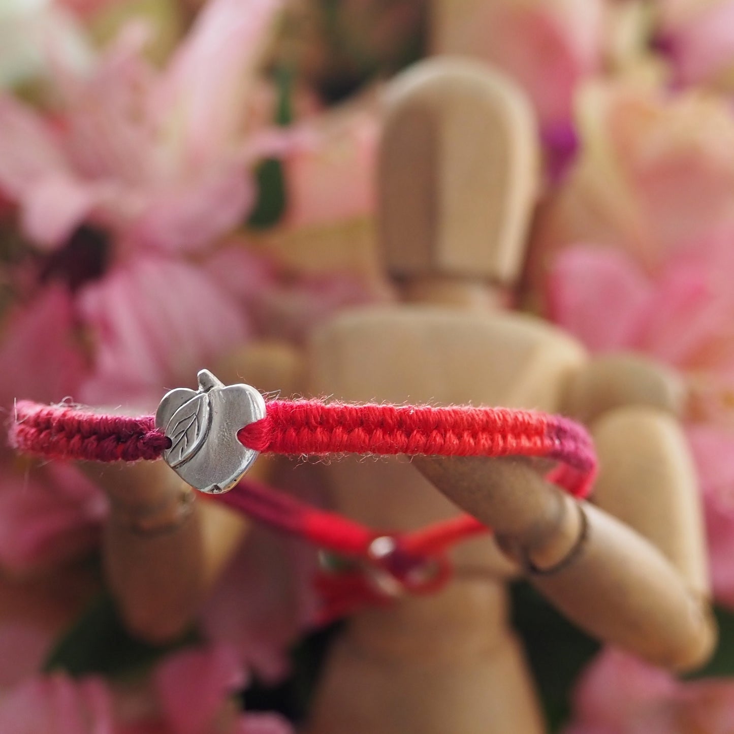 A gorgeous deep red leather and cotton friendship bracelet with a lovely tiny handmade fine silver apple.