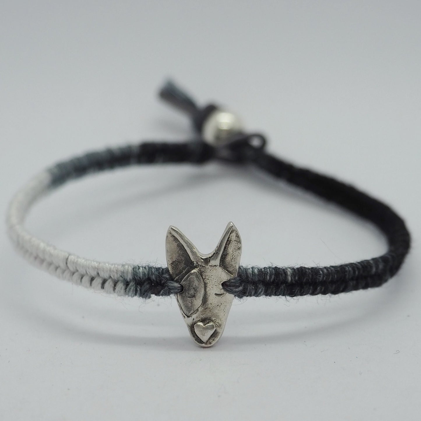 A unique adorable handmade fine silver bull dog on a beautiful grey and black leather, sterling silver and cotton friendship bracelet.