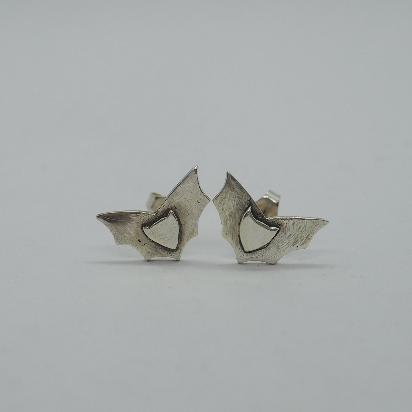 A gorgeous simple pair of bat earrings handmade in fine silver on sterling silver posts.
