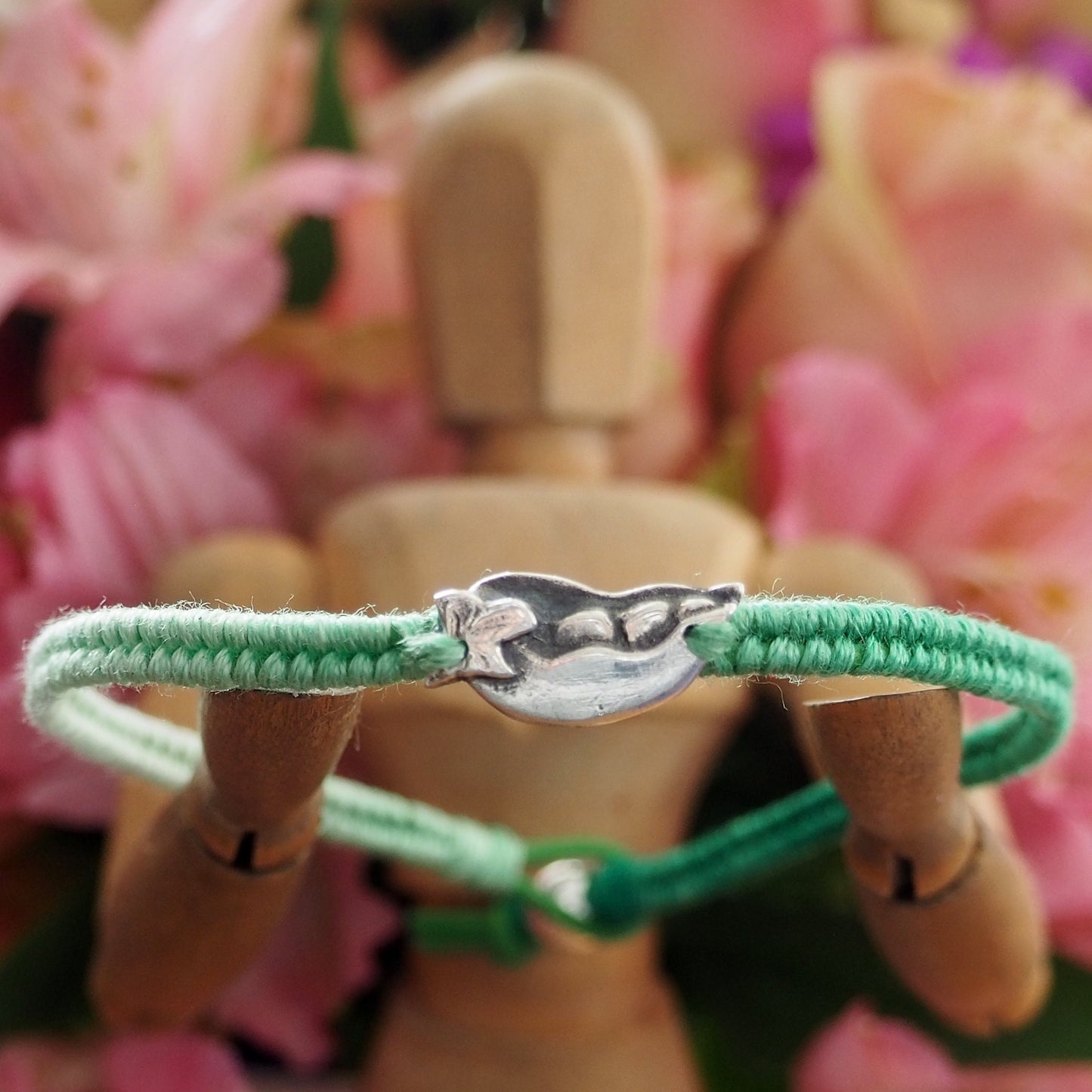 A gorgeous tropical palm tree hand made in fine silver on a fading green leather, cotton and sterling silver friendship bracelet.