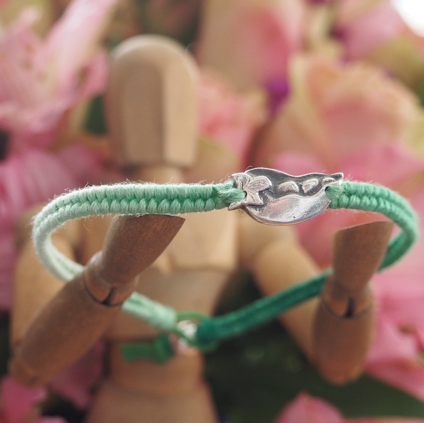 A gorgeous tropical palm tree hand made in fine silver on a fading green leather, cotton and sterling silver friendship bracelet.
