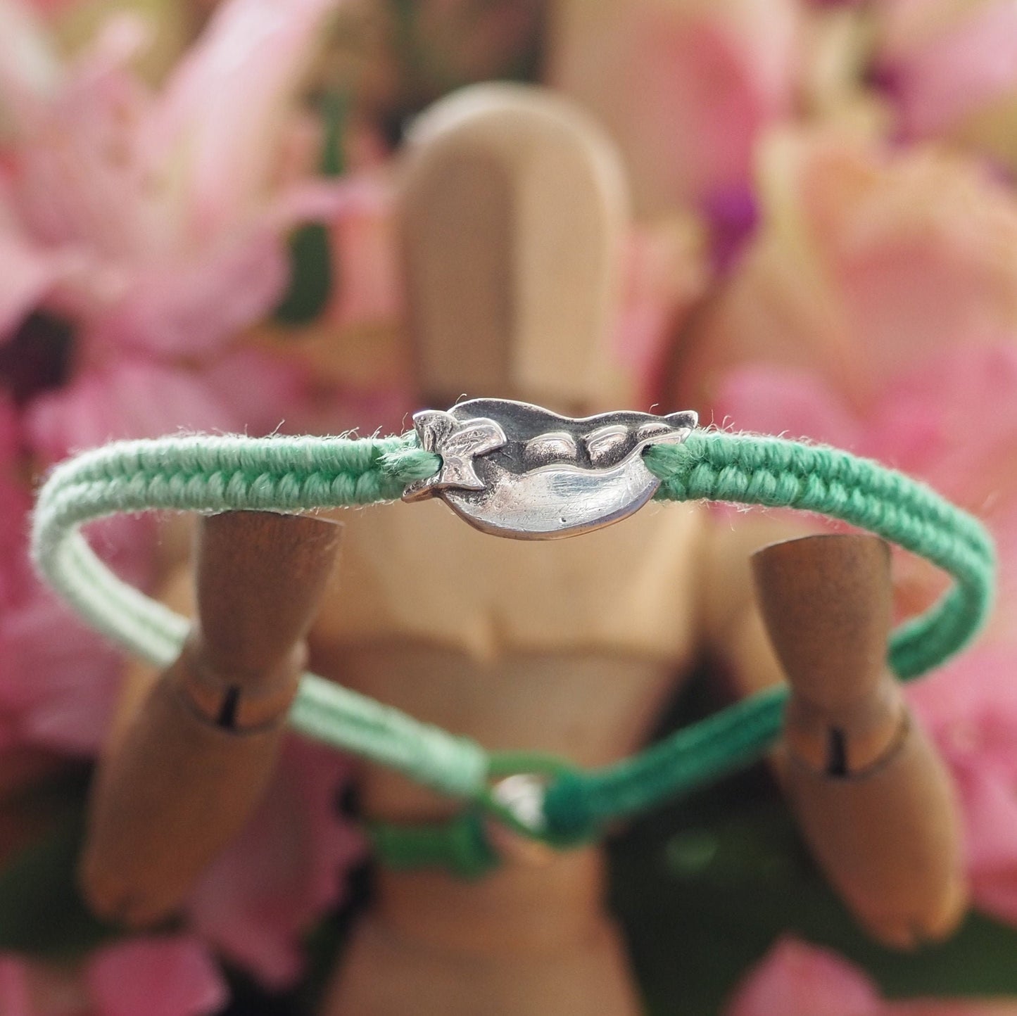 A gorgeous tropical palm tree hand made in fine silver on a fading green leather, cotton and sterling silver friendship bracelet.