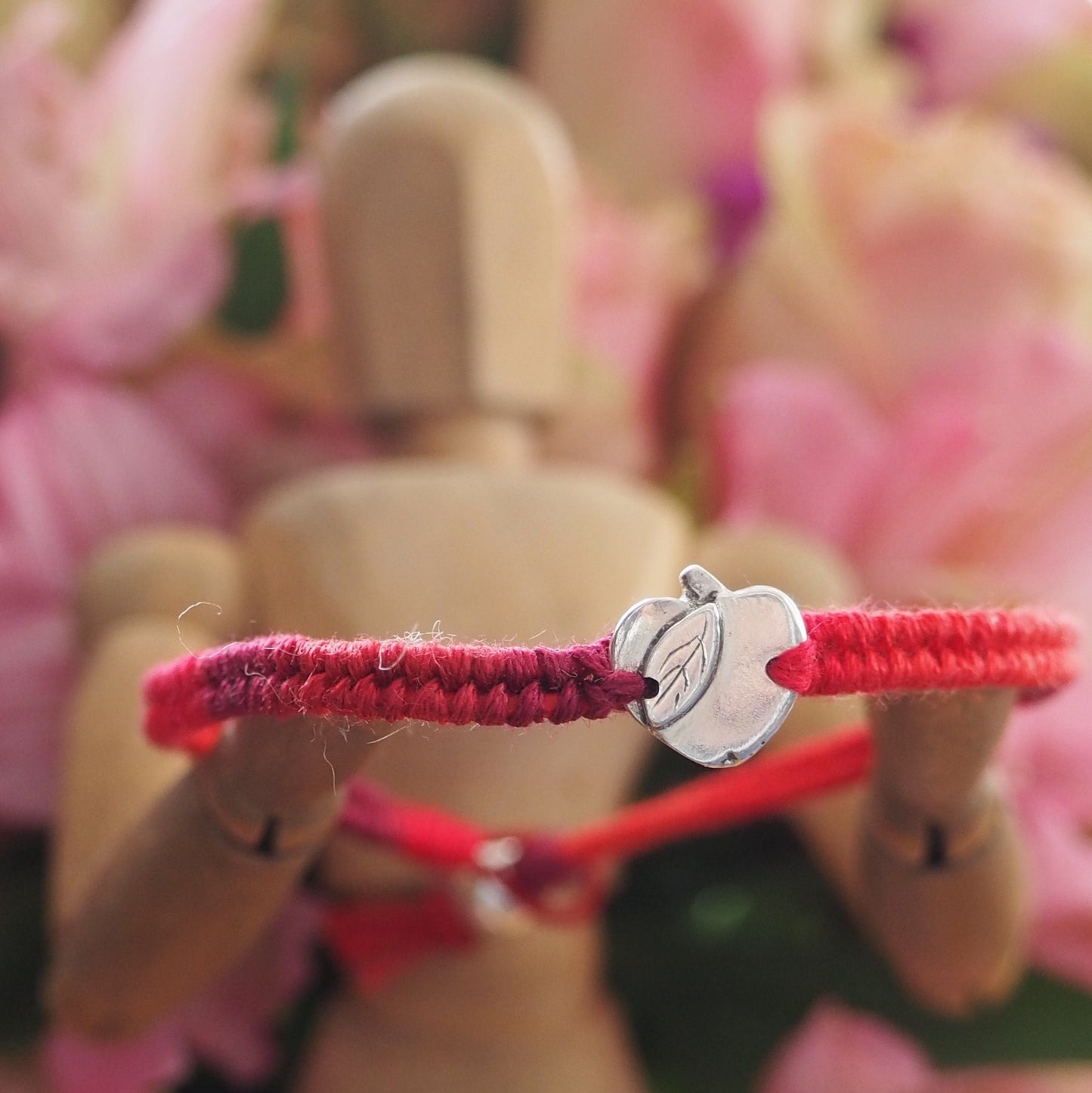 A gorgeous deep red leather and cotton friendship bracelet with a lovely tiny handmade fine silver apple.